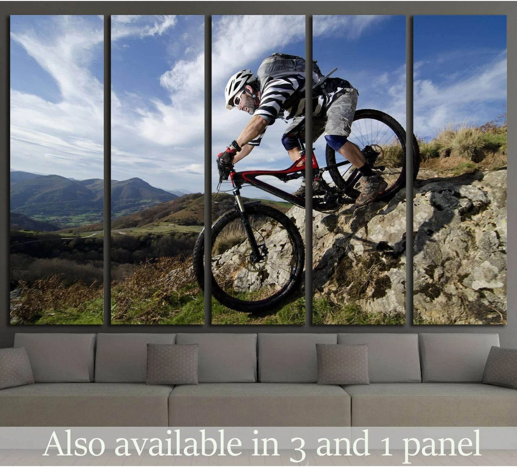 Mountain biker descending rocky trail canvas print above sofa in modern living room