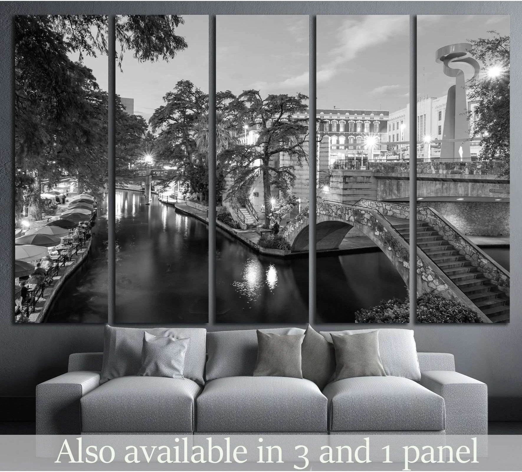Black and white San Antonio River Walk canvas print displayed above a sofa in a modern living room