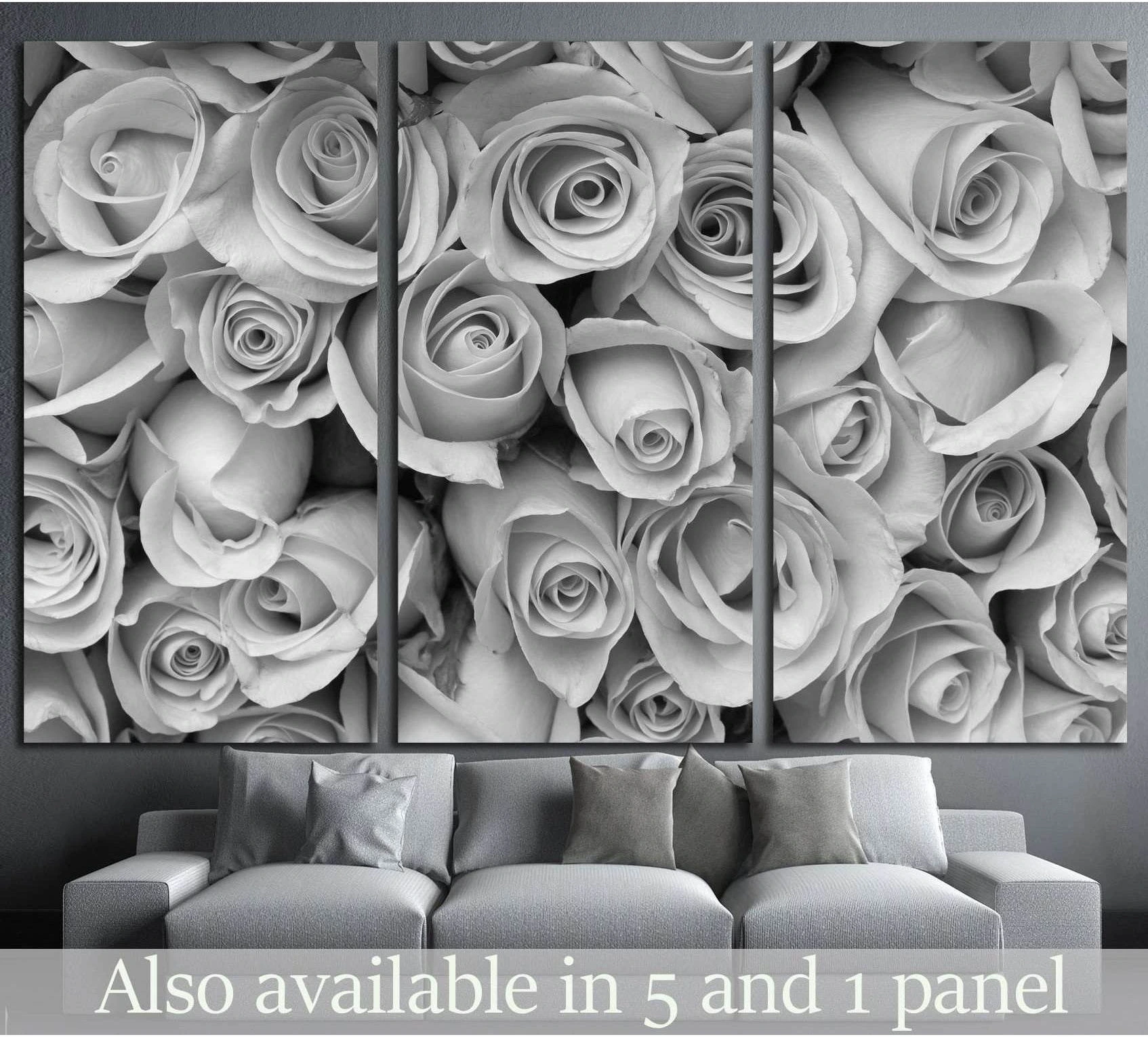 Black and white rose bouquet triptych canvas print hung above a gray sofa in a modern living room