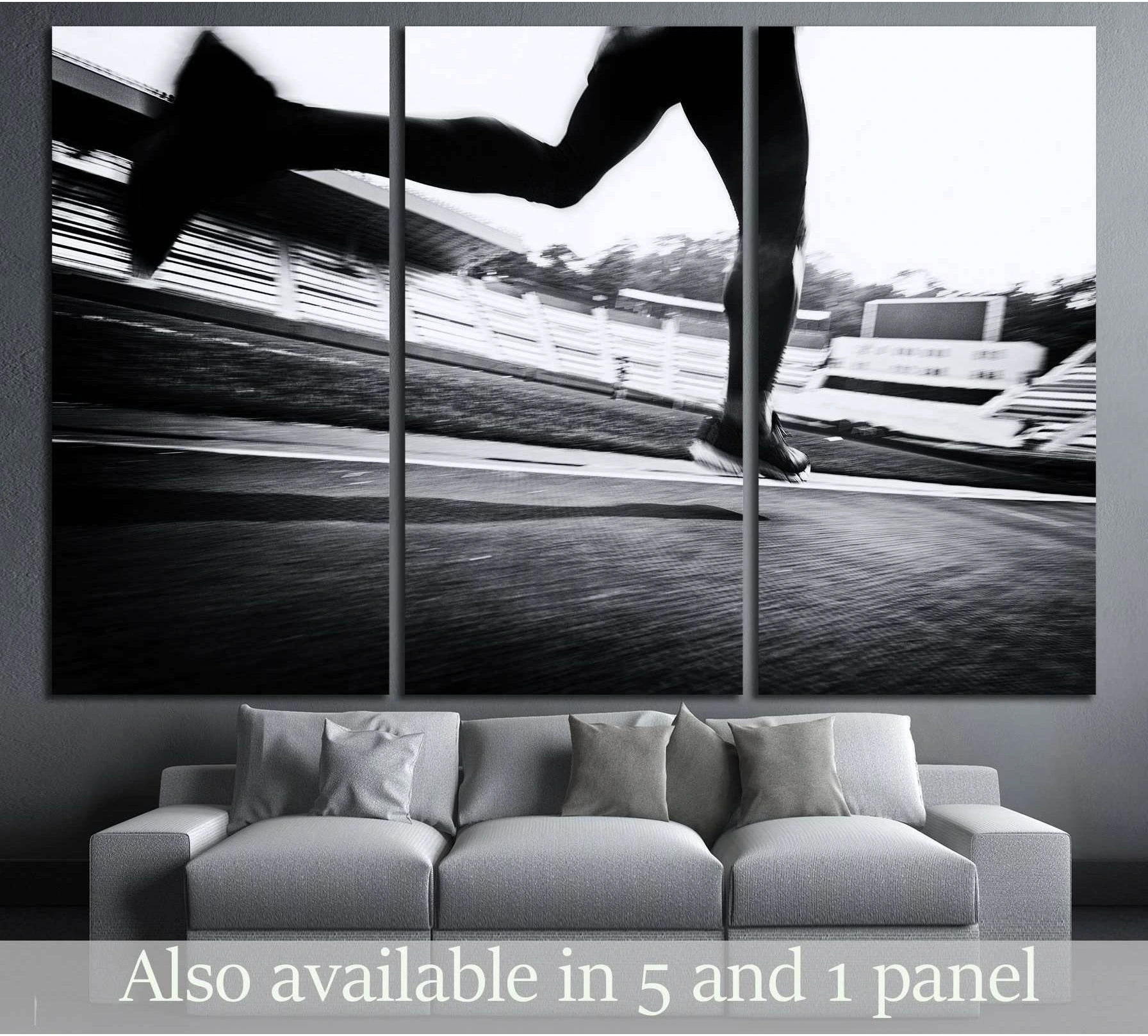 Black and white runner on track canvas print hung above a sofa in a modern living room
