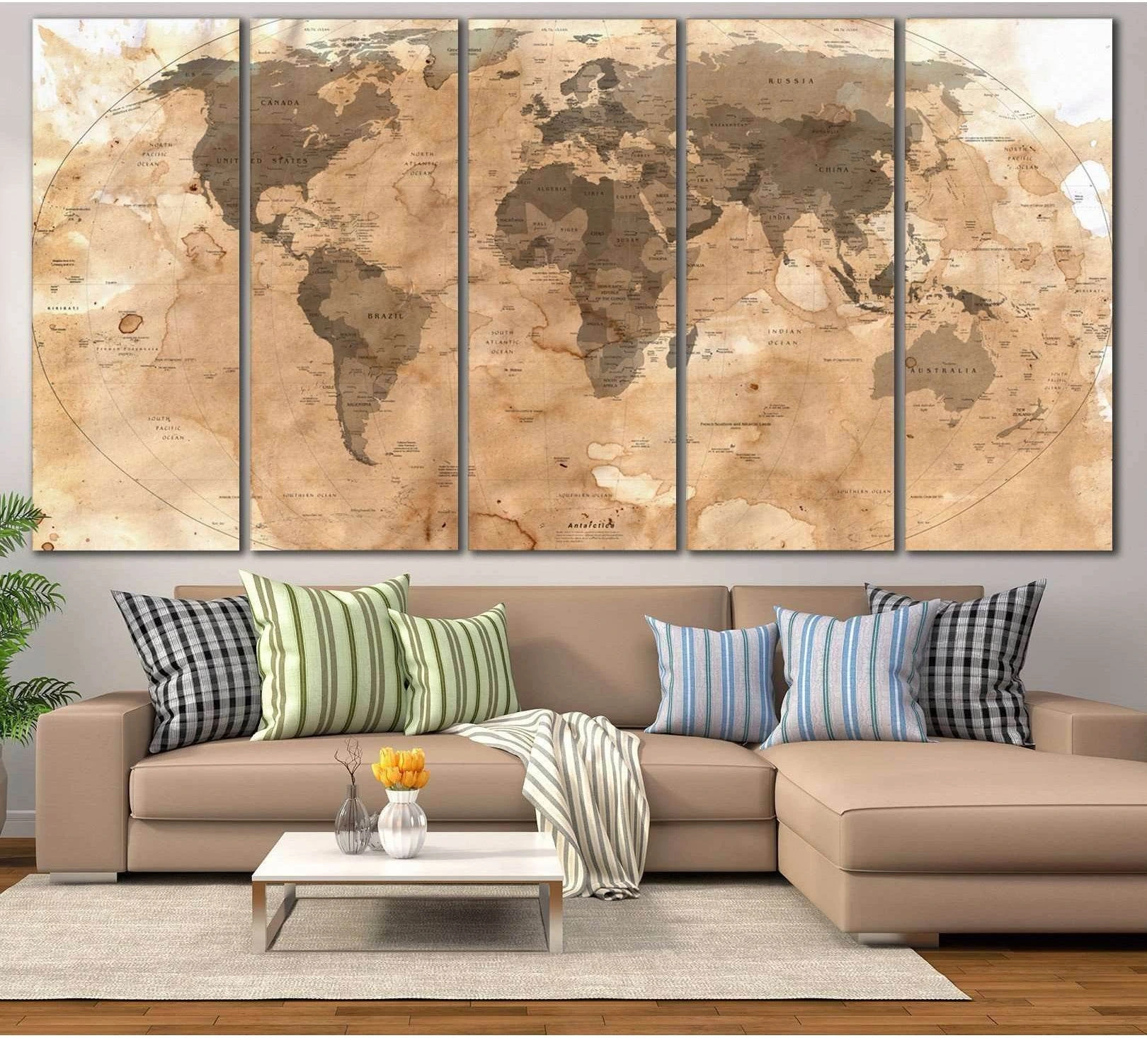 Five-panel rustic world map canvas print in warm sepia tones above a sofa in a neutral living room