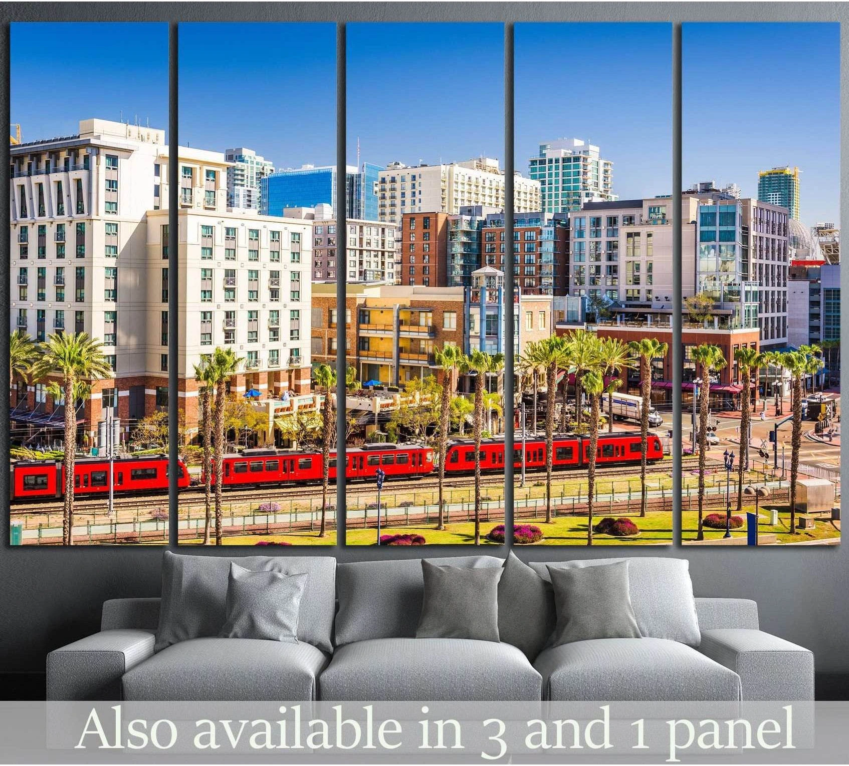San Diego red trolley canvas print with palm trees and downtown skyline hung above a gray sofa