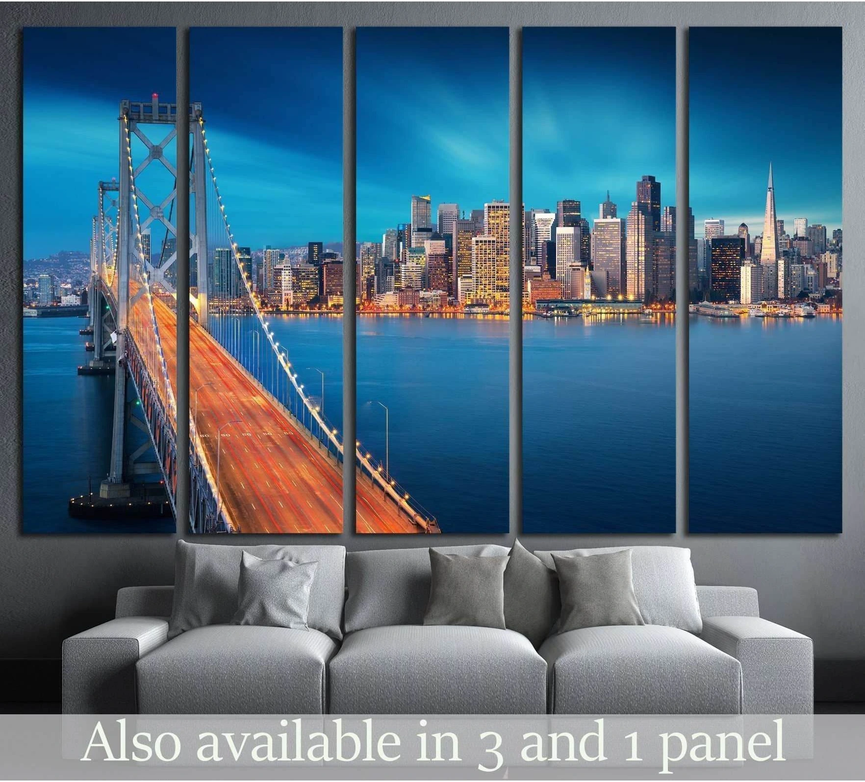 San Francisco Bay Bridge canvas print with blue skyline and water, displayed above a sofa in a modern living room