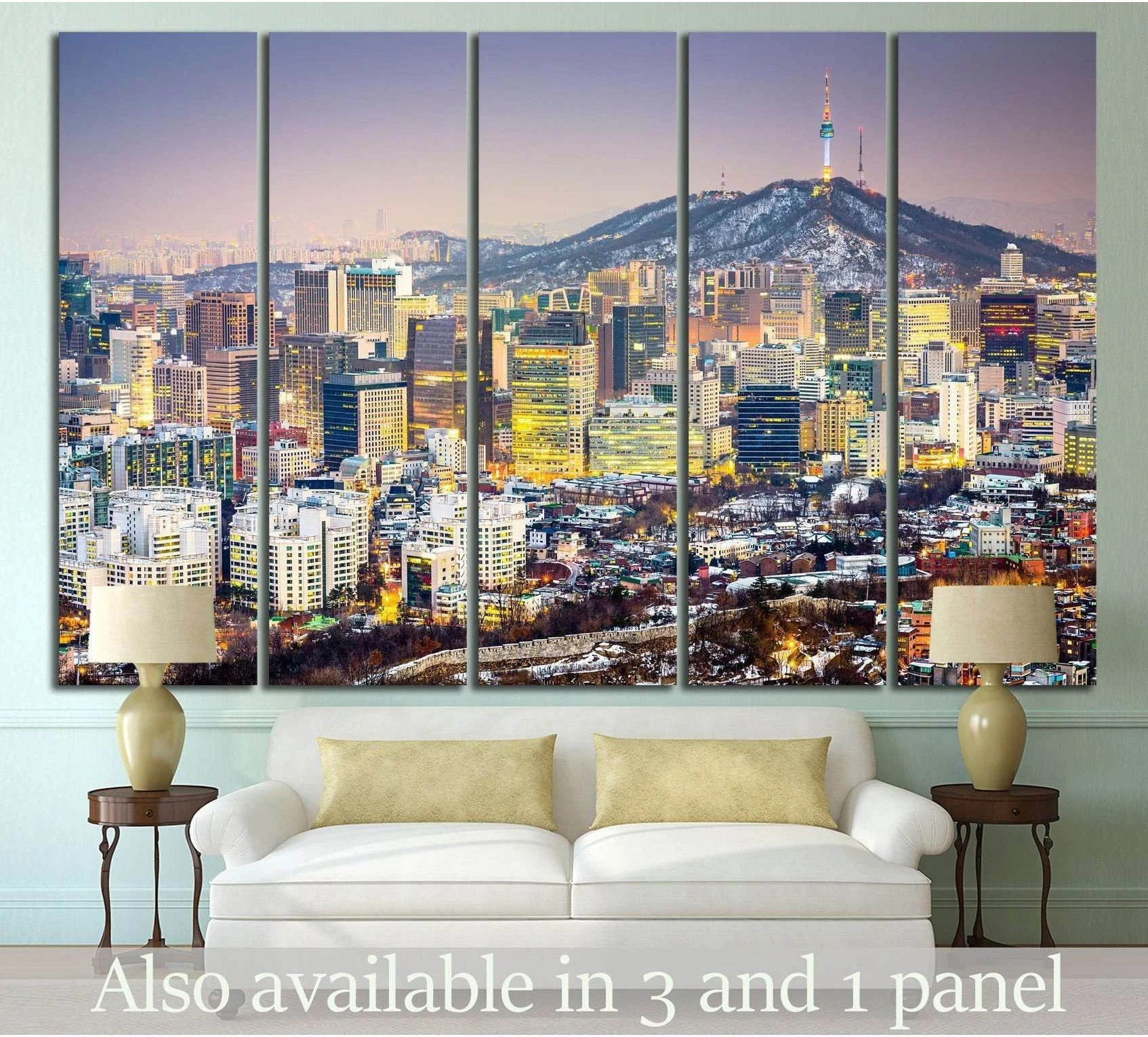 Seoul skyline canvas print with Namsan Tower at dusk, displayed above a sofa in a modern living room