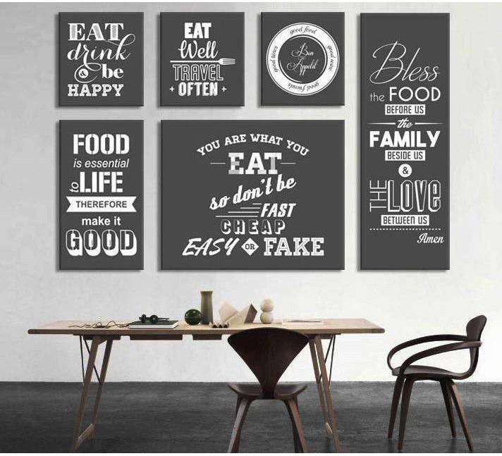 Set of 6 farmhouse kitchen typography canvas prints in black and white chalkboard style above dining table