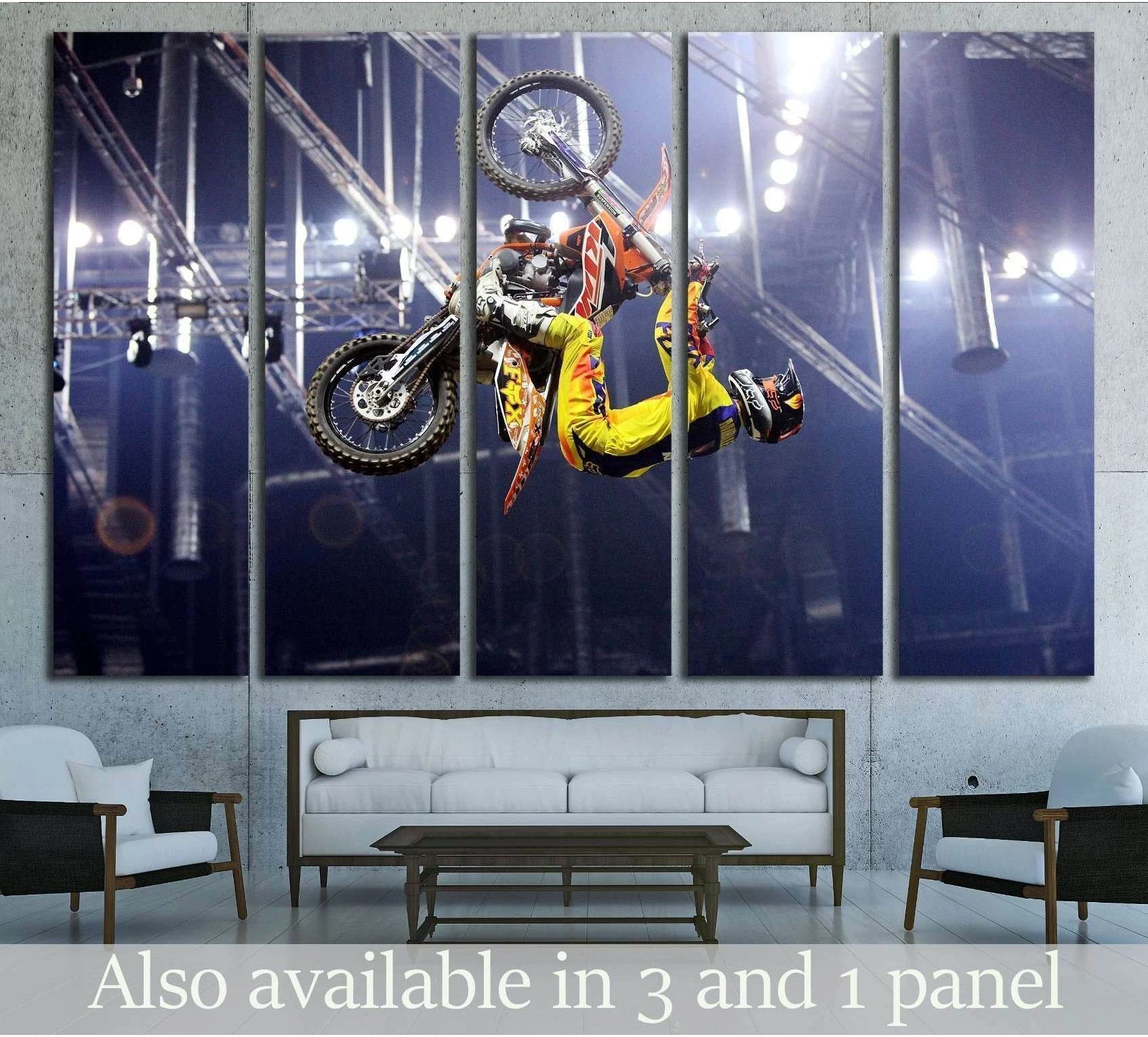 FMX motocross canvas print with rider upside down mid-jump under arena lights above a sofa
