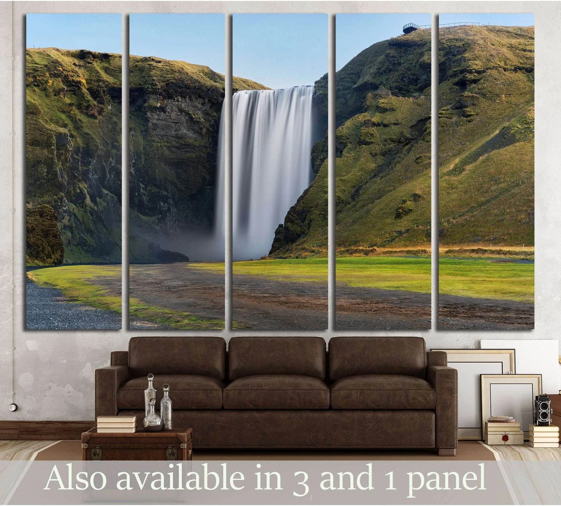Skogafoss waterfall canvas print with long-exposure white falls between mossy green Iceland cliffs above a sofa