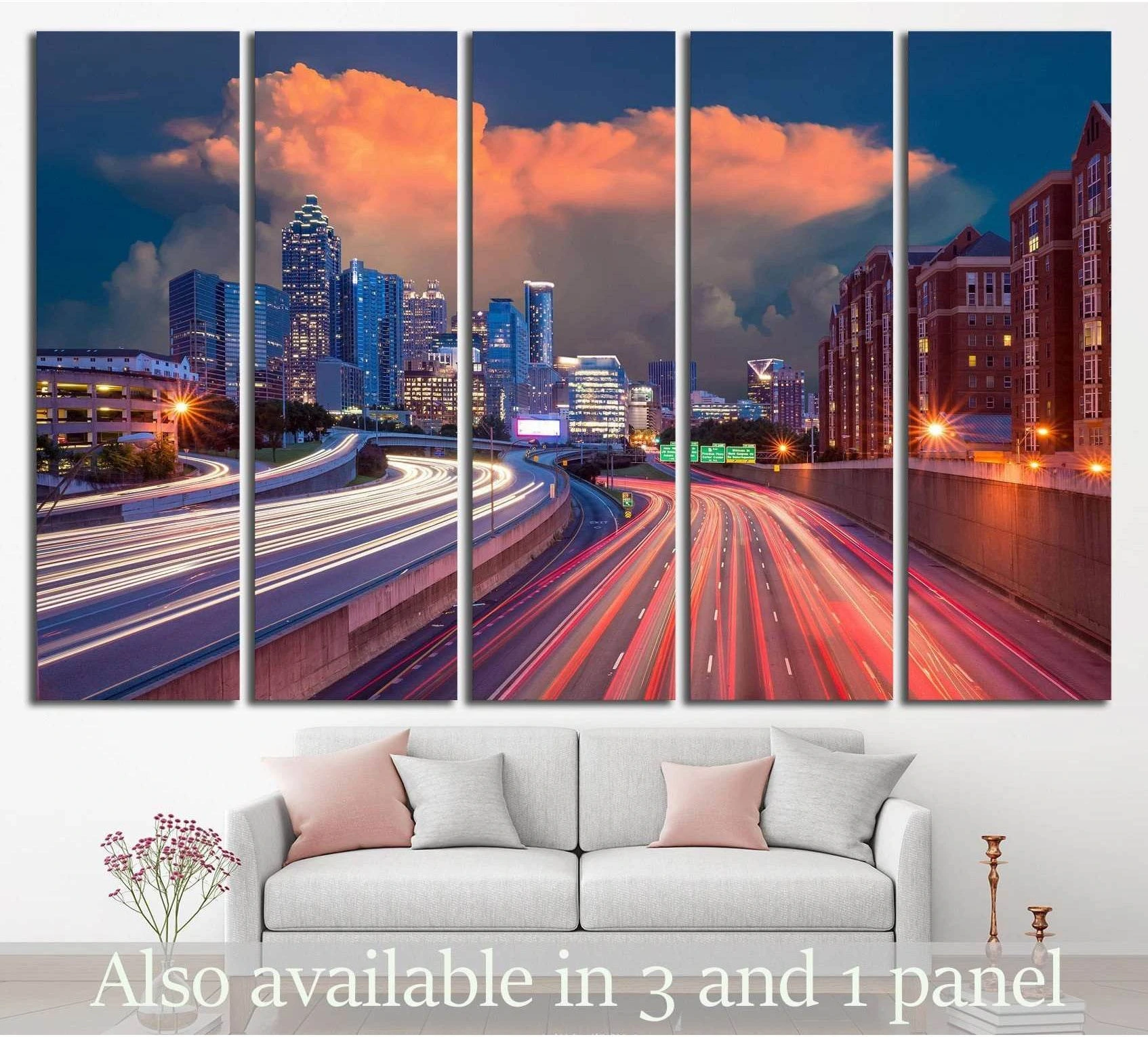 Atlanta skyline canvas print with sunset clouds and highway light trails above a sofa in a modern living room