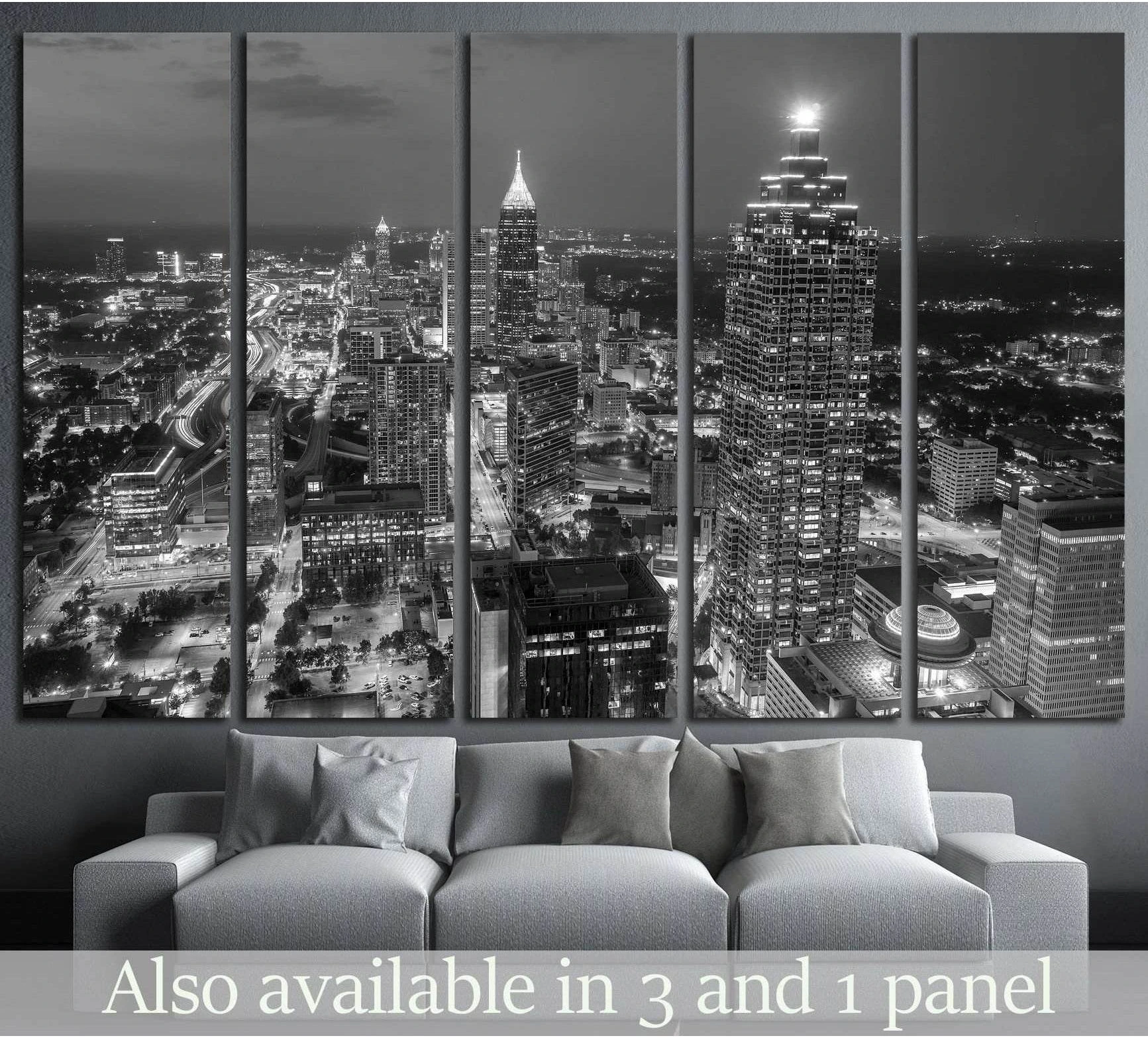 Black and white Atlanta skyline canvas print in a 5-panel layout, displayed above a gray sofa in a modern living room
