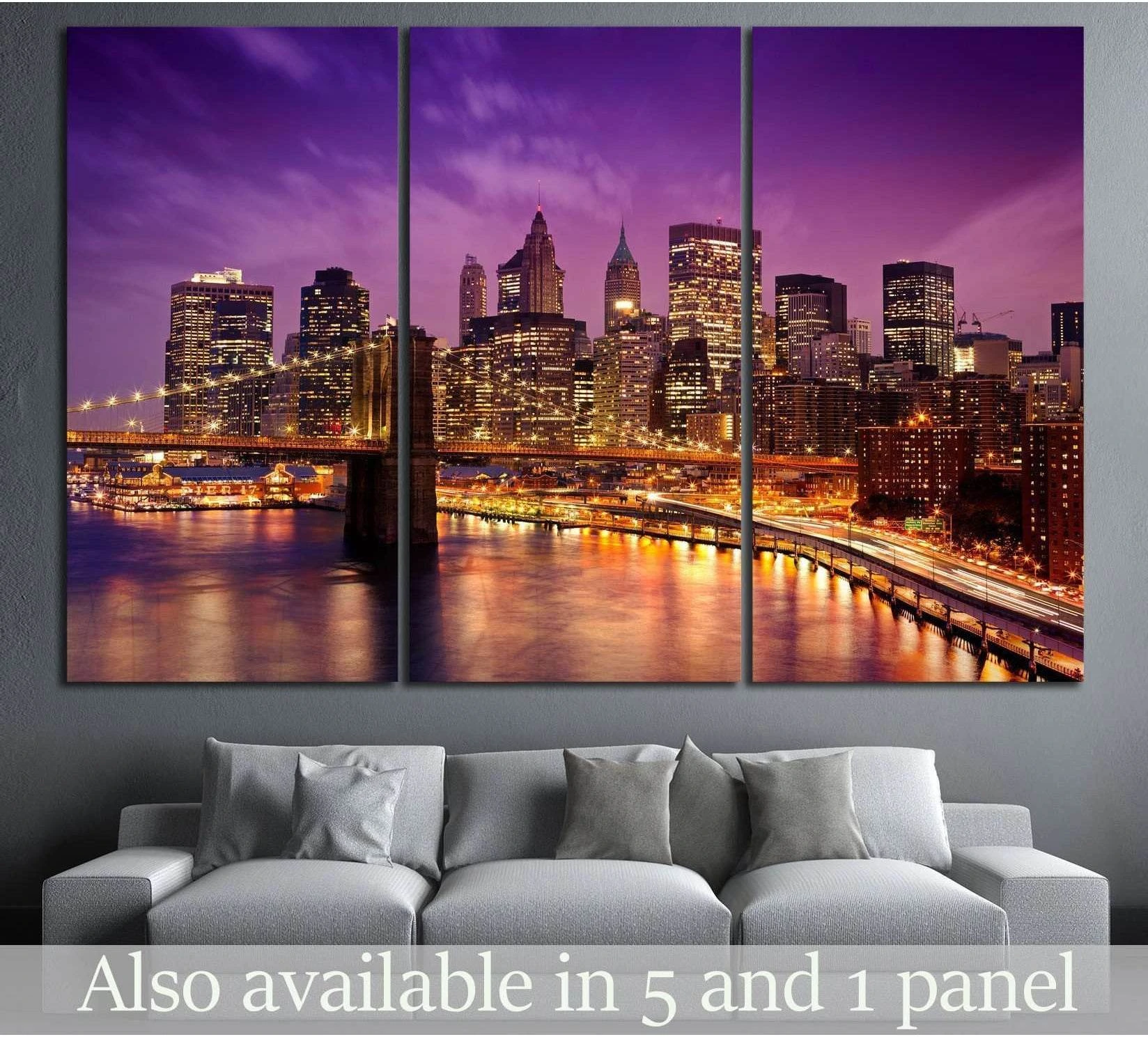 New York skyline triptych canvas print with Brooklyn Bridge at dusk above a sofa