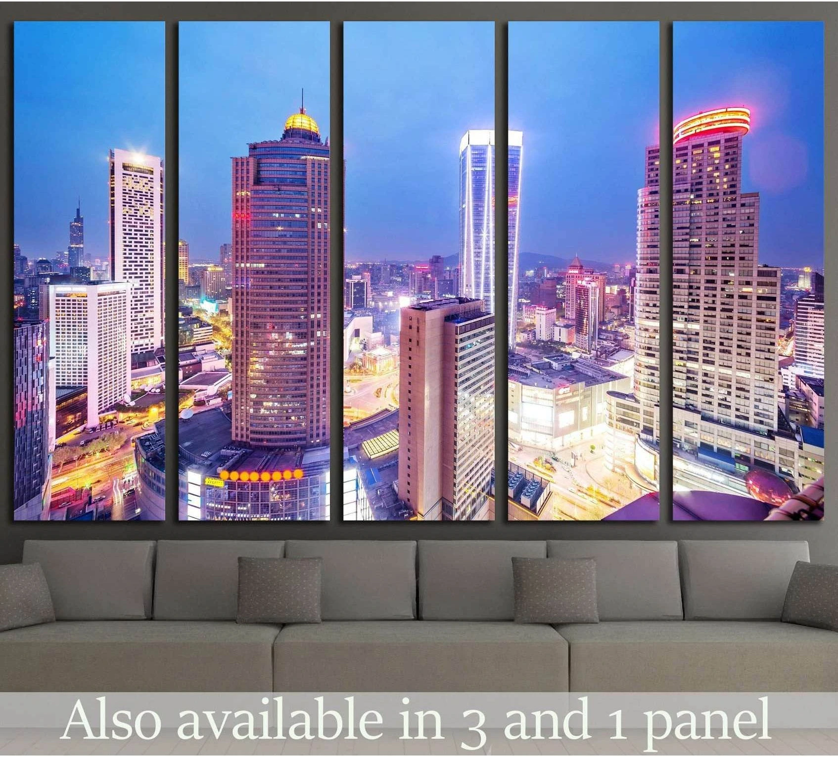 Neon city skyline canvas print with glowing office towers at night above a gray sofa