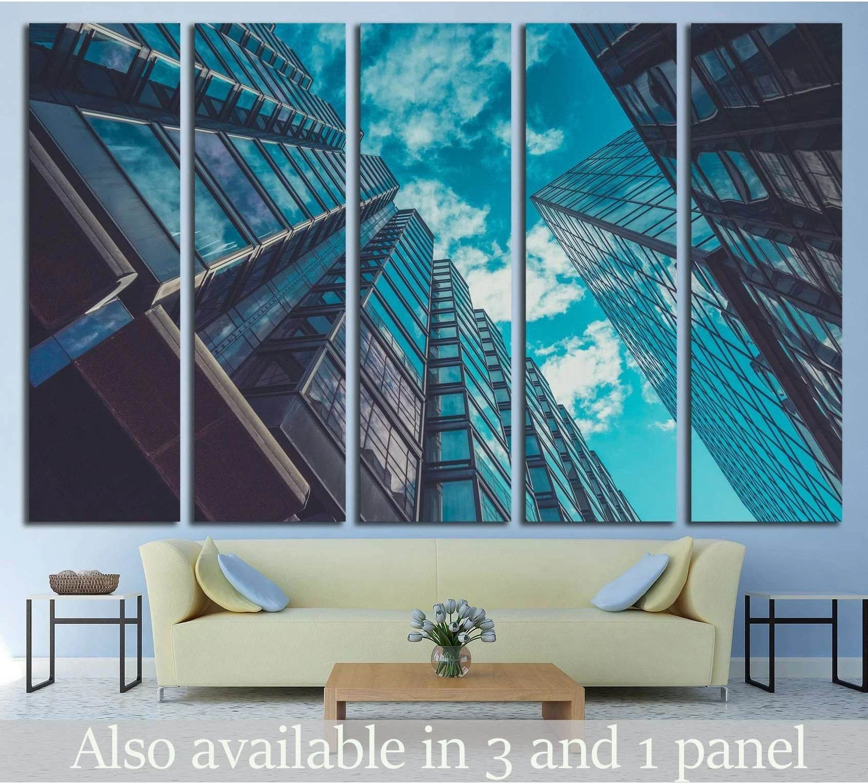 Upward view of glass skyscrapers canvas print hung above a sofa in a modern living room