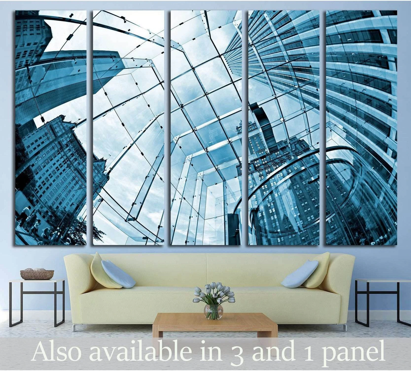 Blue skyscraper canvas print with glass atrium view, displayed above a sofa in a modern living room