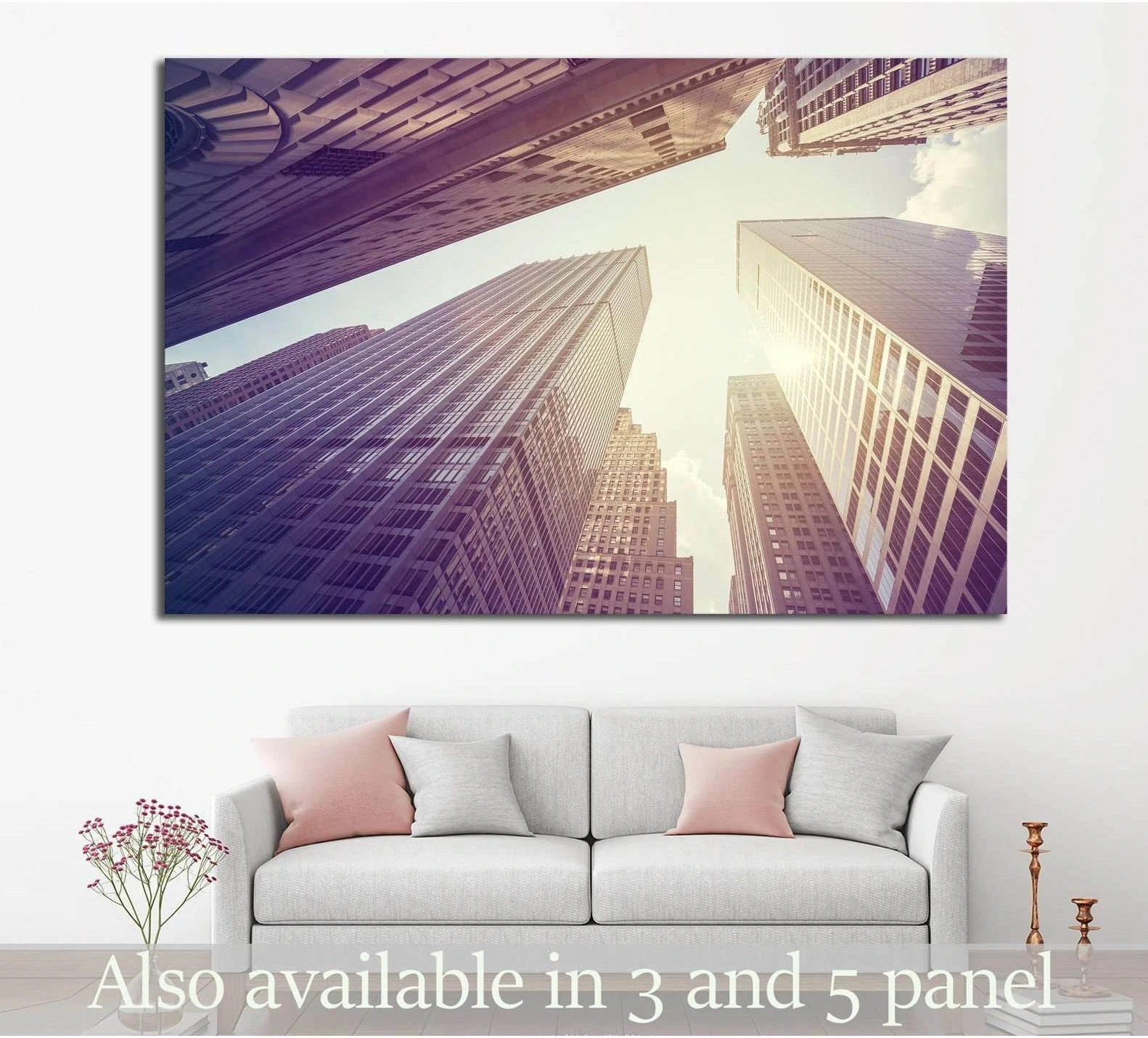 Upward view of Manhattan skyscrapers canvas print in warm sepia tones above a modern sofa