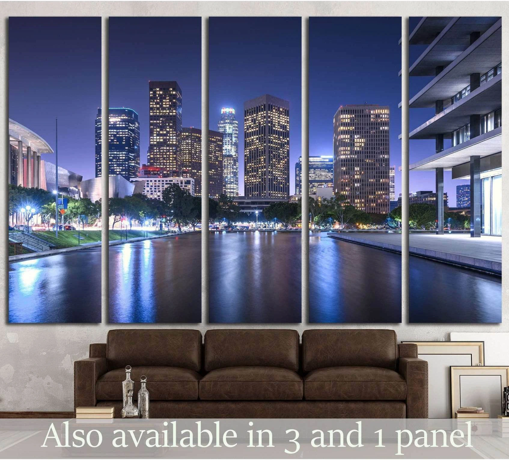 Los Angeles skyline canvas print with blue night reflections, hung above a sofa