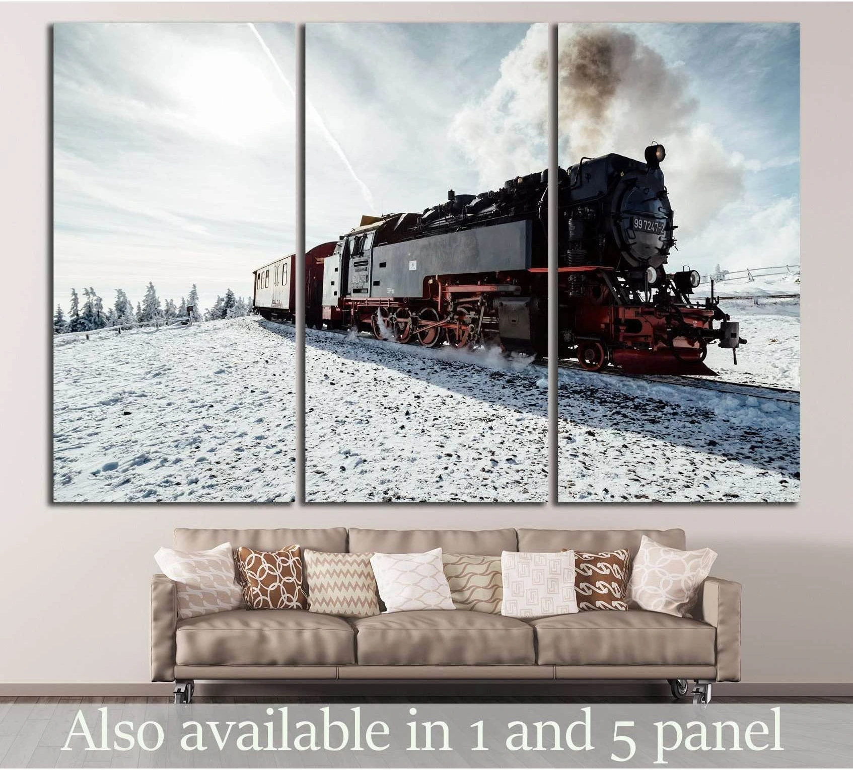 Steam locomotive canvas print in snowy landscape displayed above sofa in a modern living room