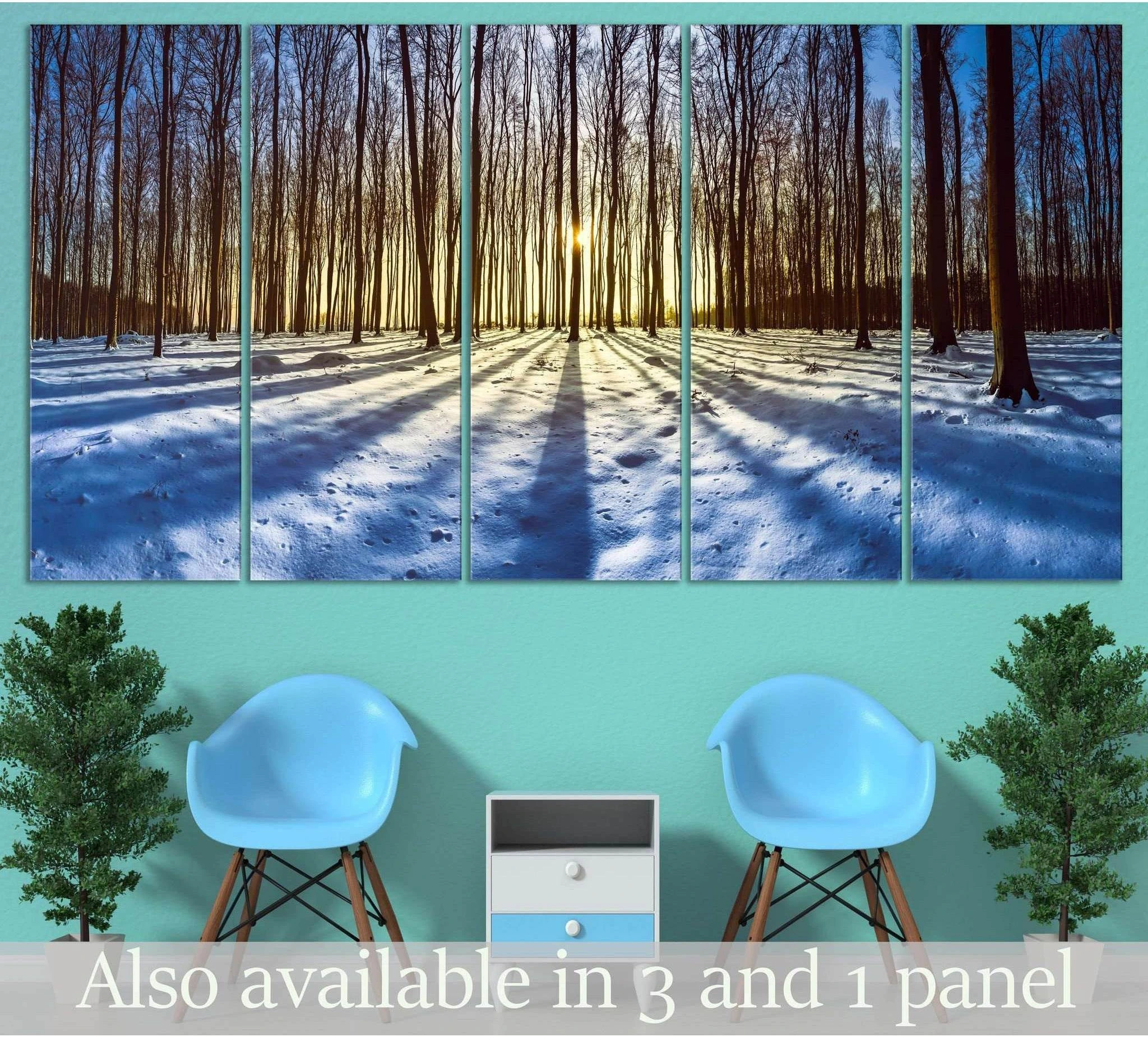 Winter forest canvas print with sunrise over blue snow and long tree shadows, displayed as multi-panel wall art above chairs