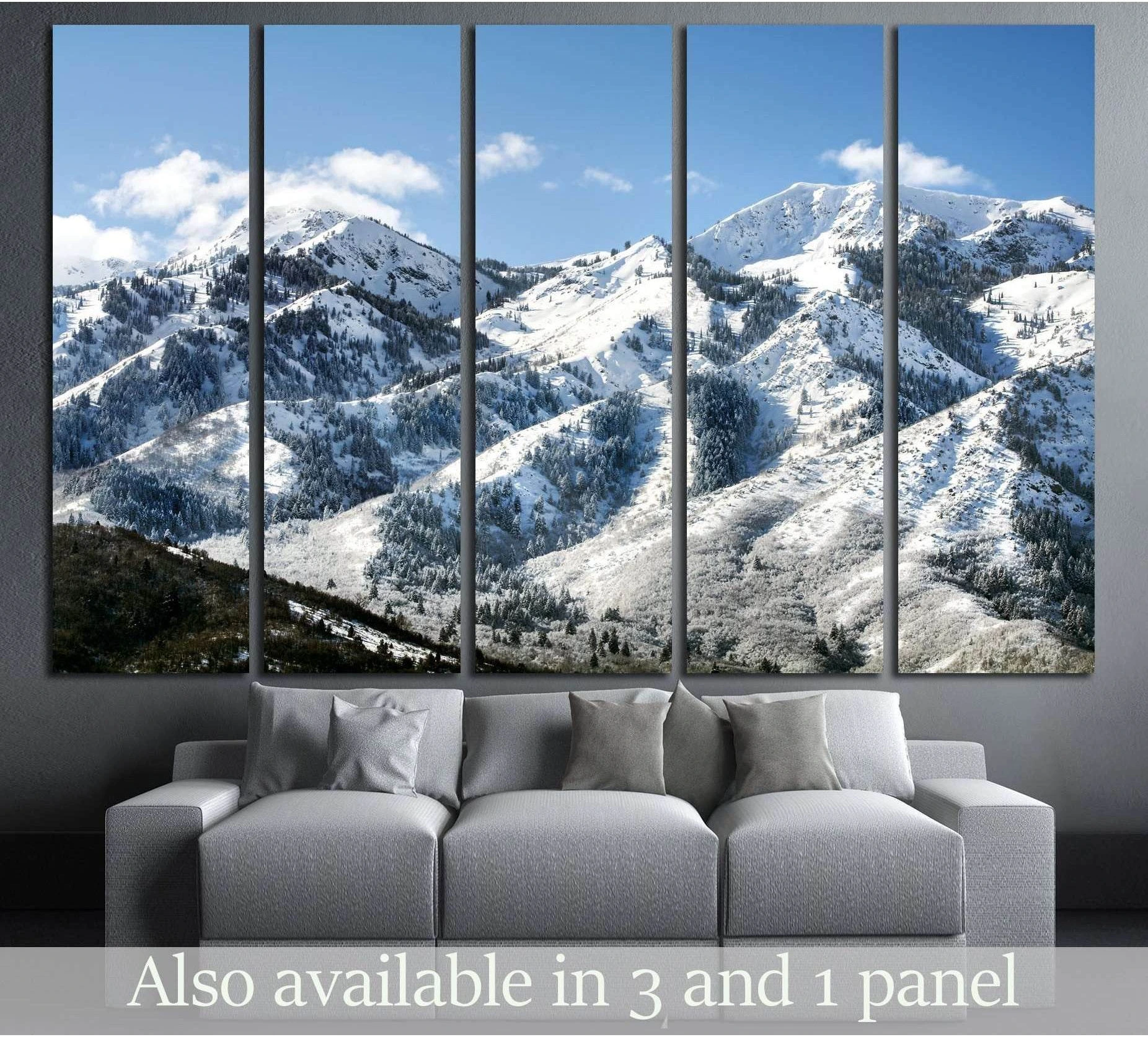 Snowy mountain canvas print in 5-panel wall display above a sofa with forested alpine peaks and blue sky