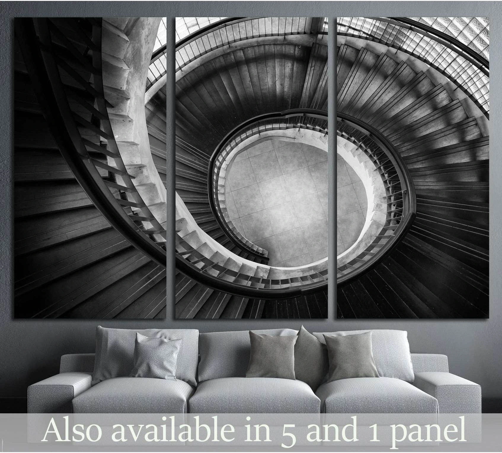 Black and white spiral staircase canvas print hung above a sofa in a modern living room