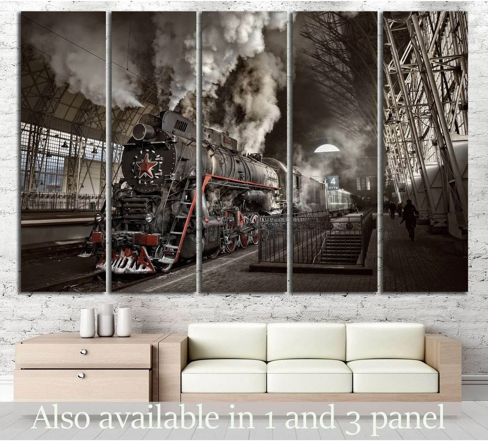 Sepia steam train canvas print at a covered railway station, displayed above a sofa in a modern living room