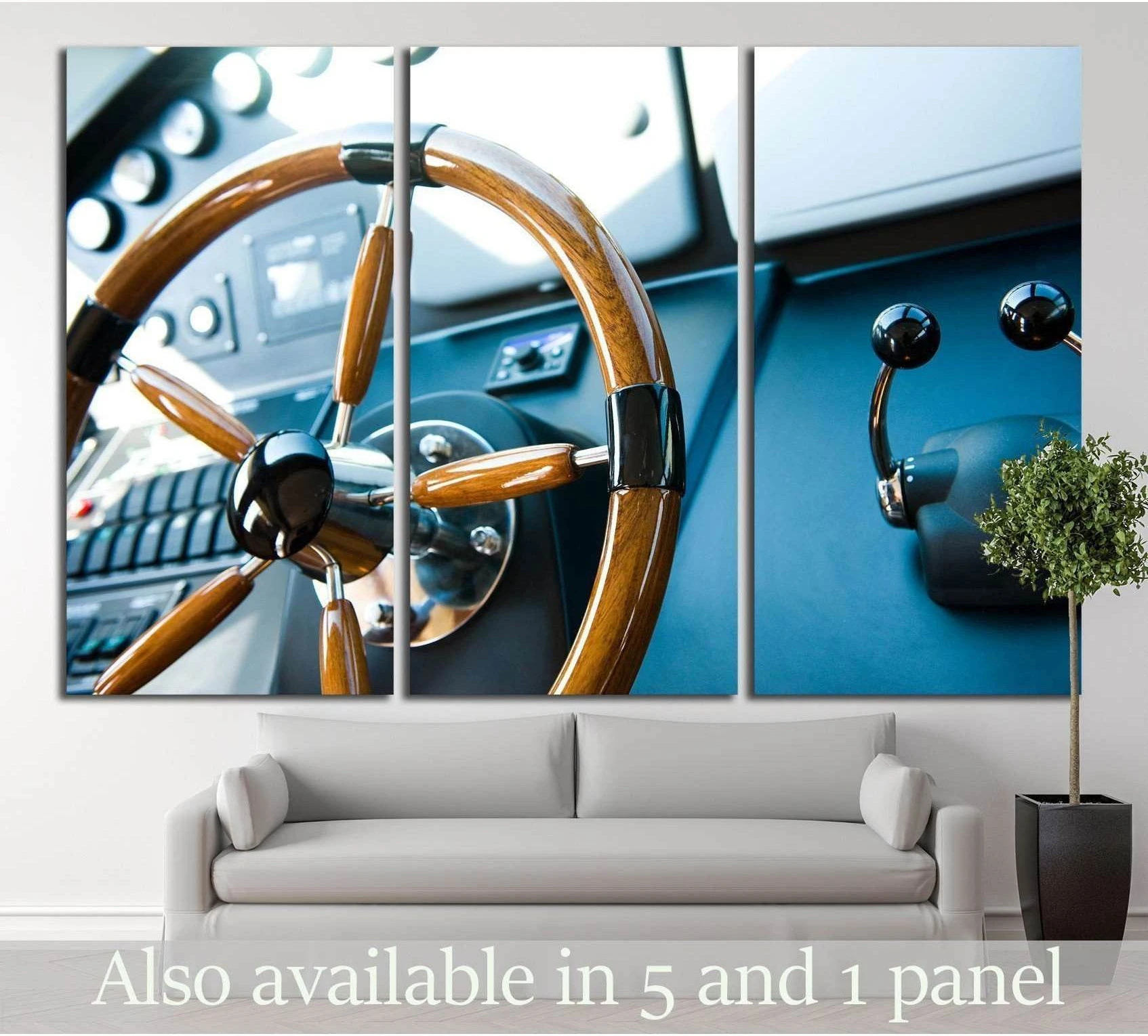 Steering wheel on a luxury yacht showing blue ocean wall art with water and coastal depth.
