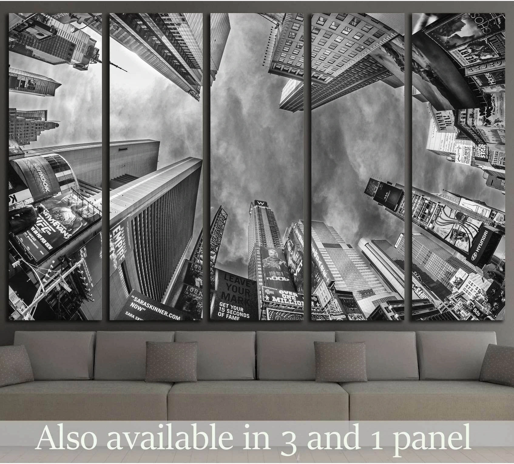 Black and white Times Square skyscrapers canvas print in multi-panel layout above a sofa in a modern living room