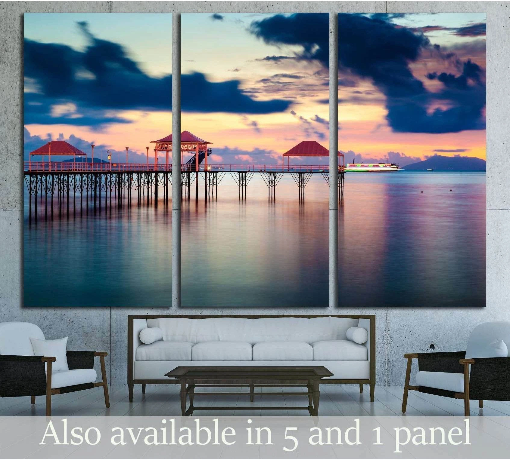 Sunset pier canvas print with red-roof pavilions over calm pastel water in a coastal living room