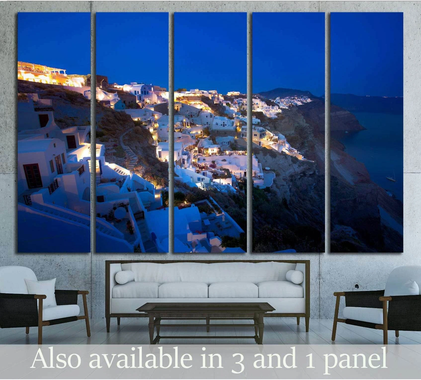 Fira Santorini canvas print in five panels above a sofa with glowing blue hour cliffside village view