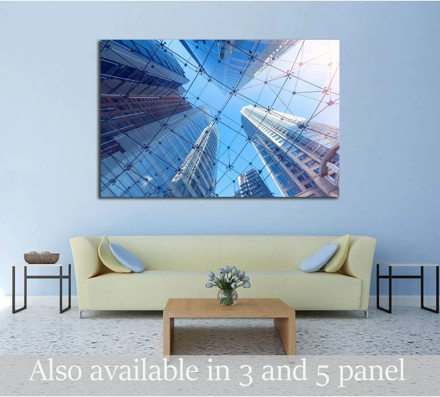 Sydney skyscraper canvas print with blue glass towers above a sofa in a modern living room