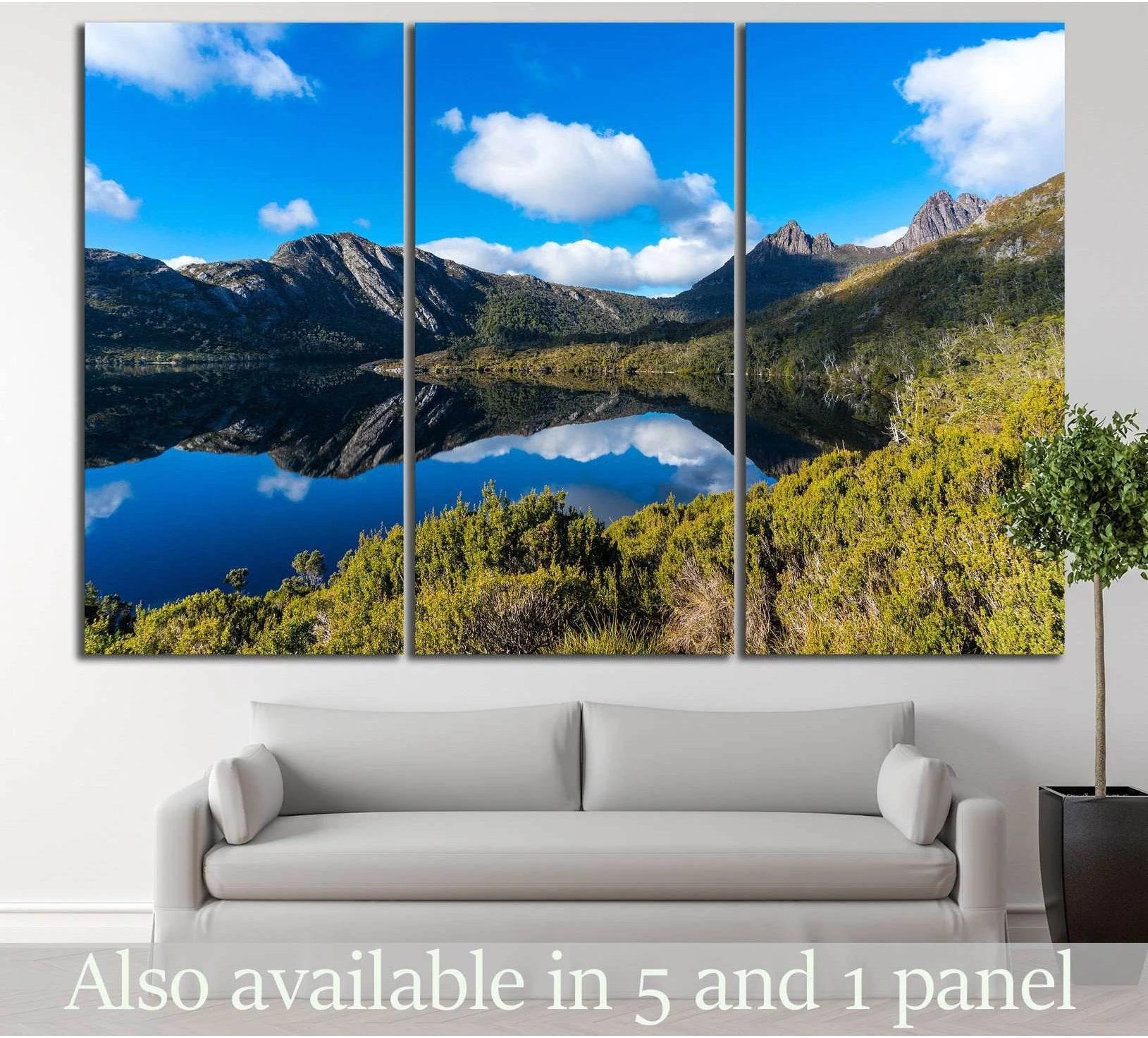 Cradle Mountain lake canvas print in triptych format above sofa in a modern living room