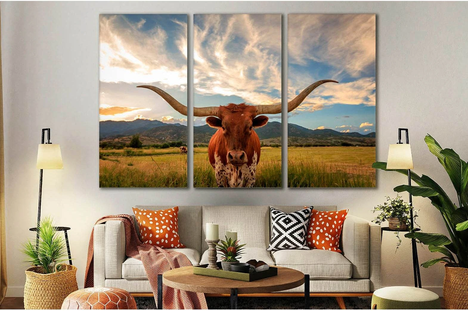 Texas longhorn canvas print with front-facing steer above sofa in a warm western living room