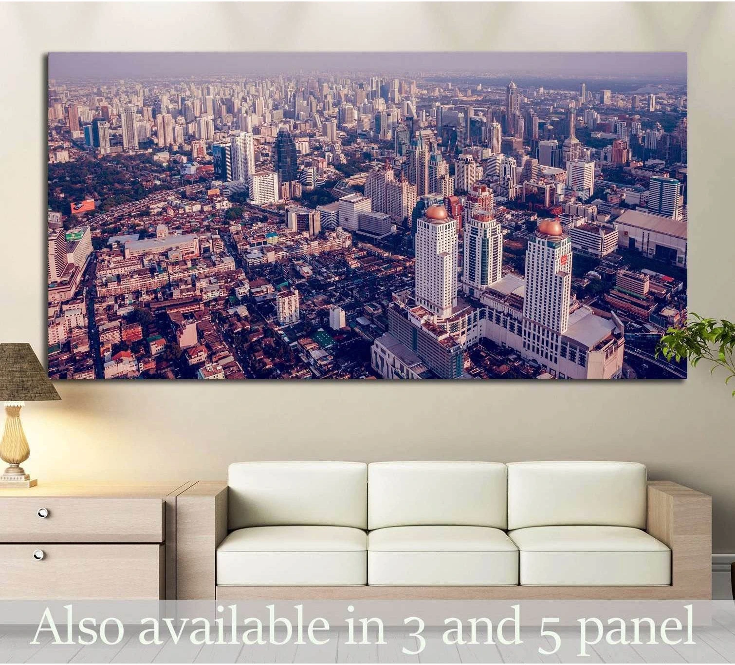 Panoramic Bangkok skyline canvas print with dense aerial city view above a sofa in a modern living room