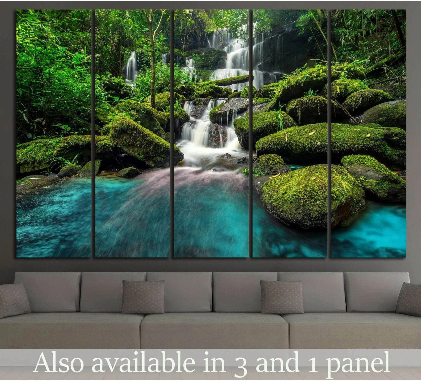 Thailand waterfall canvas print with moss-covered rocks and turquoise pool, shown above a sofa in a modern living room