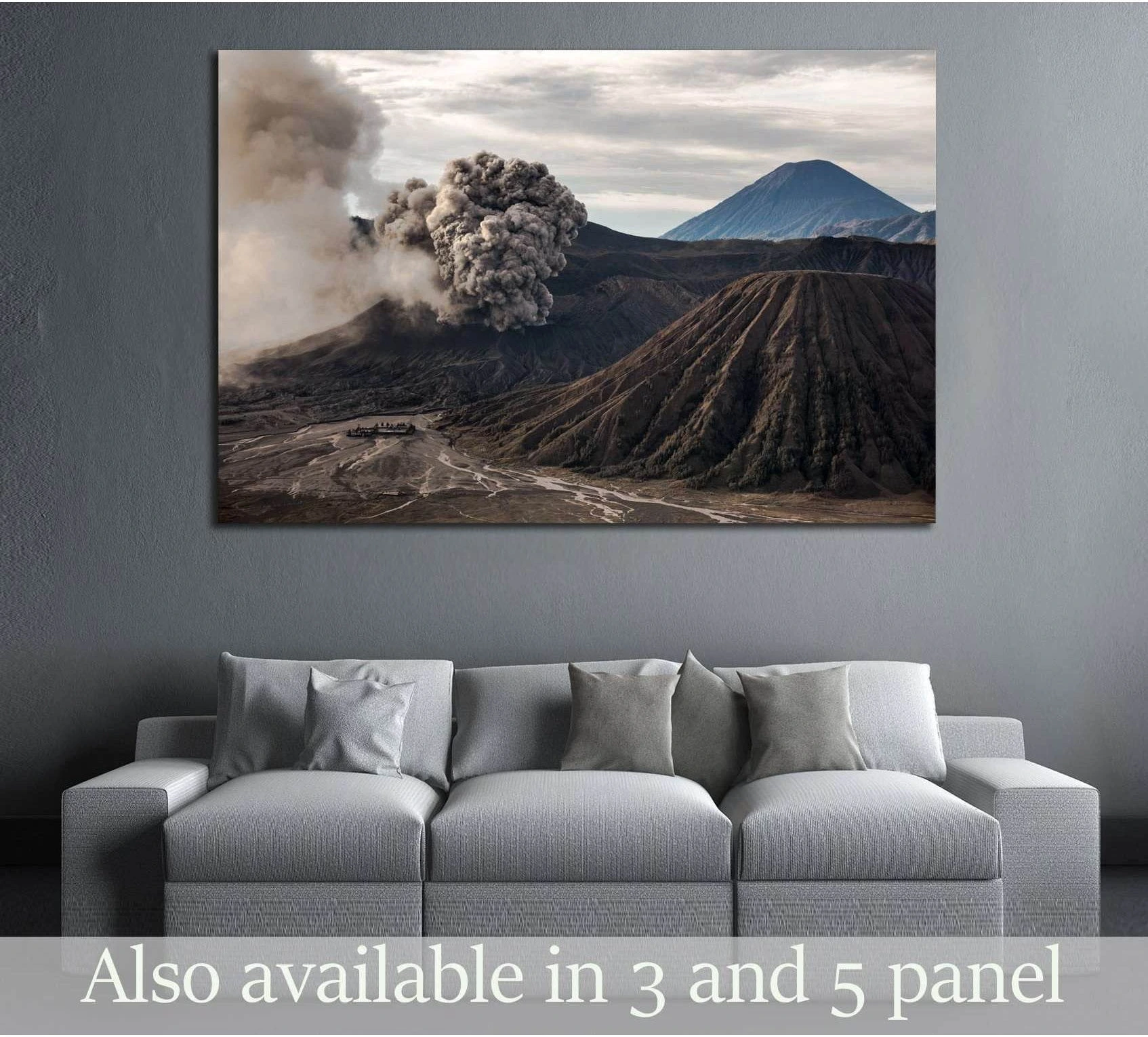 Mount Bromo volcano eruption canvas print above sofa in a modern living room with dark ridges and ash plume