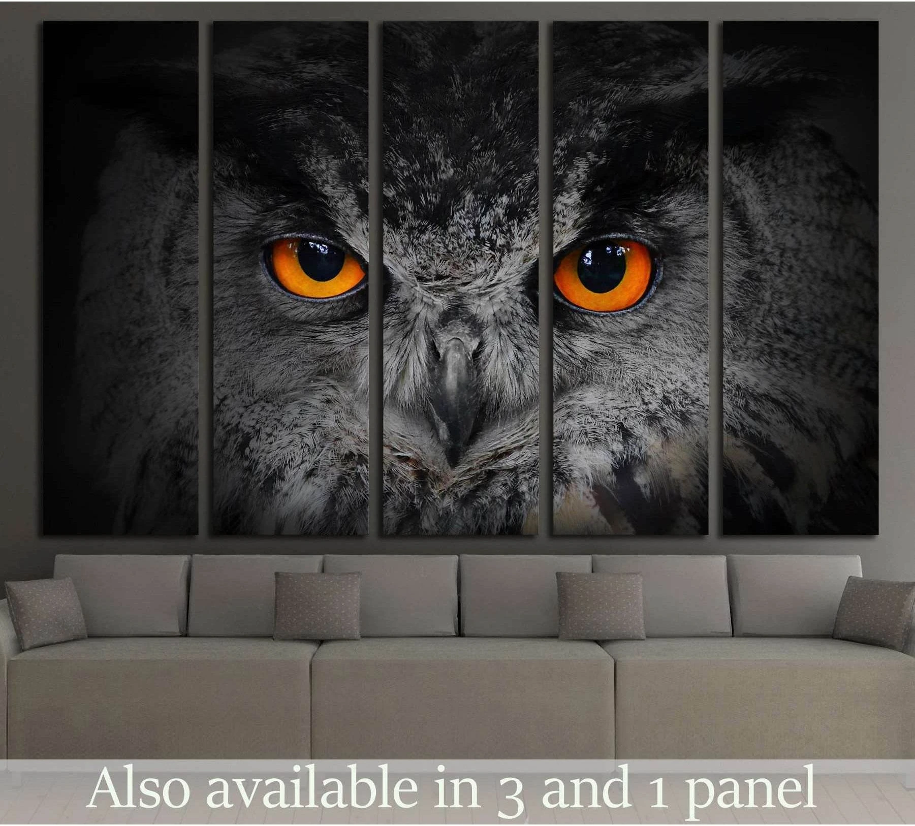 Close-up eagle owl canvas print with vivid orange eyes on a dark background above a sofa