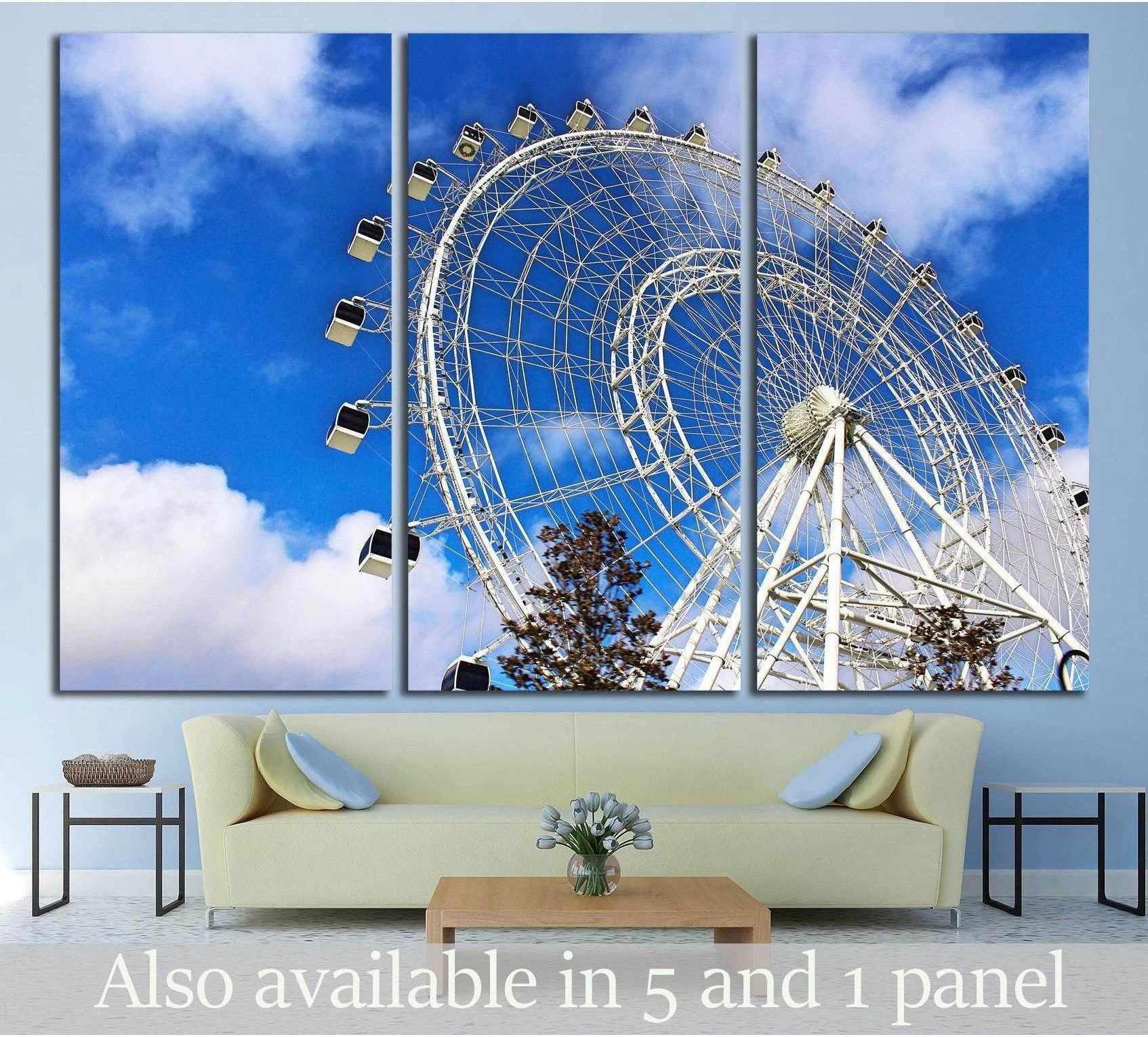 Ferris wheel canvas print split across three panels above a sofa with bright blue sky and clouds