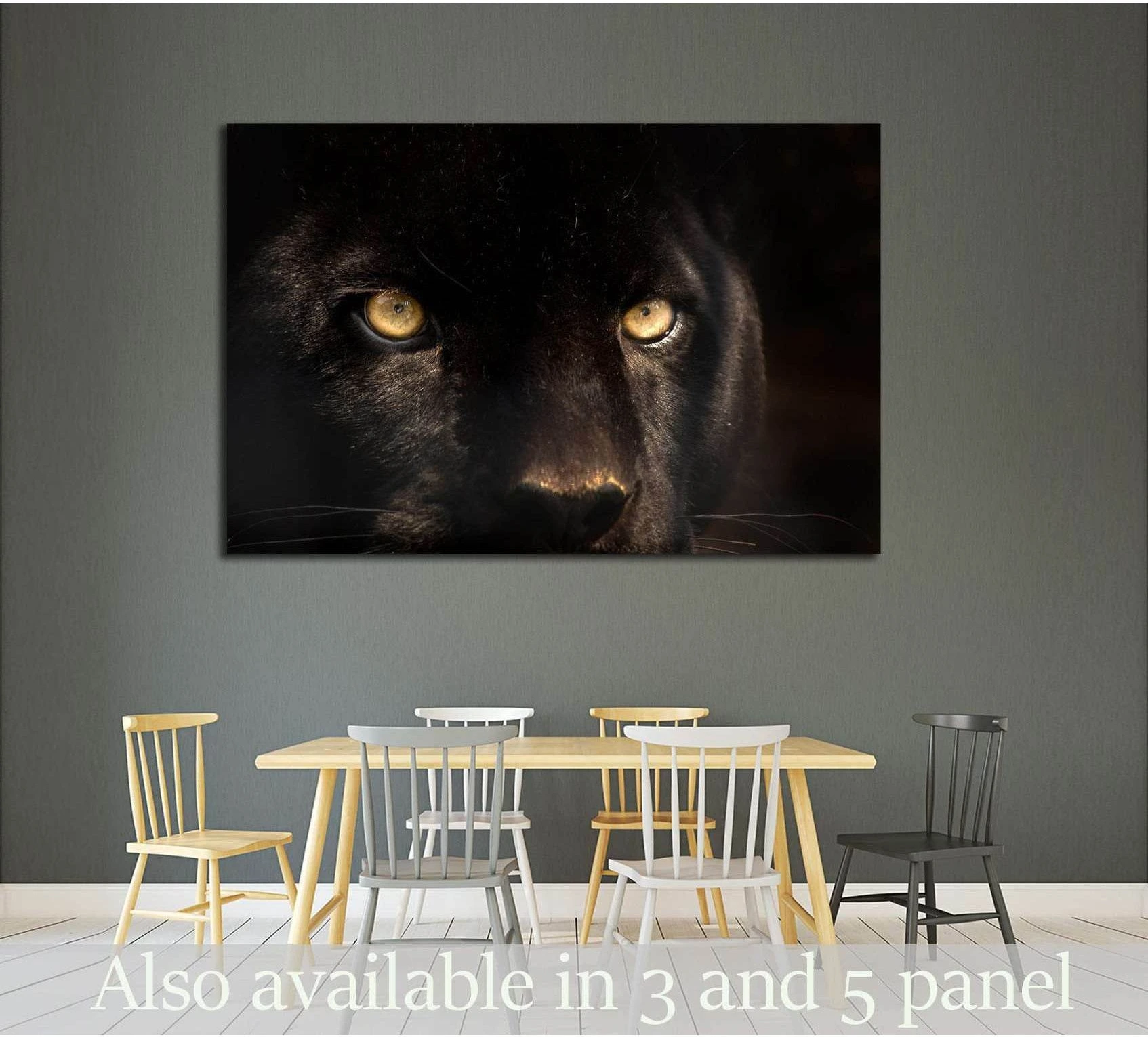 Black panther eyes canvas print hung above a dining table on a gray wall in a modern dining room