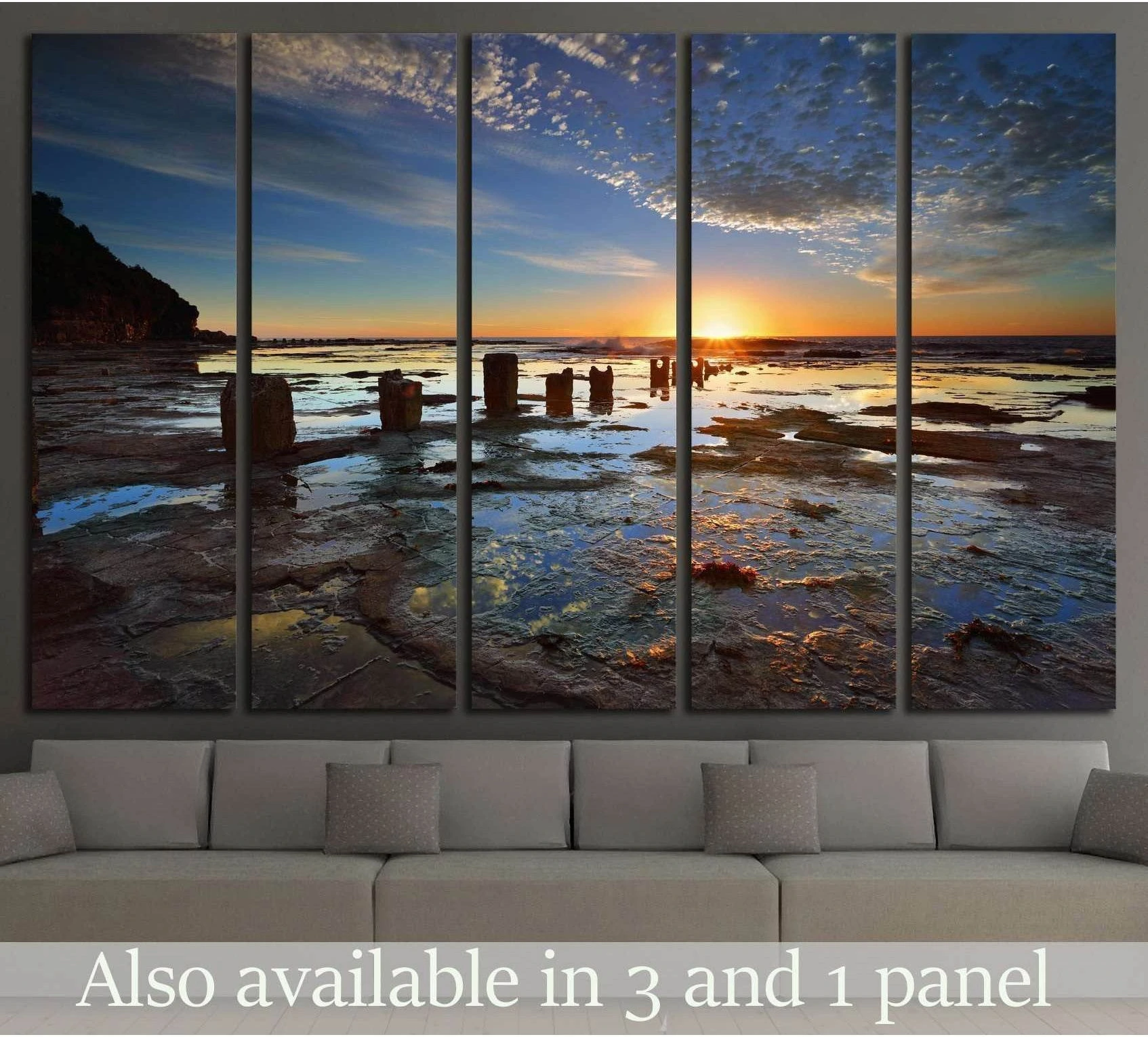 Australia sunrise canvas print over a rocky shoreline, shown above a sofa in a modern living room