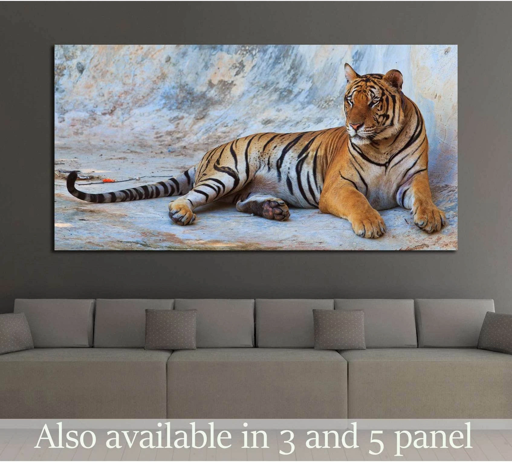 Reclining tiger canvas print above a sofa with painterly blue and beige background