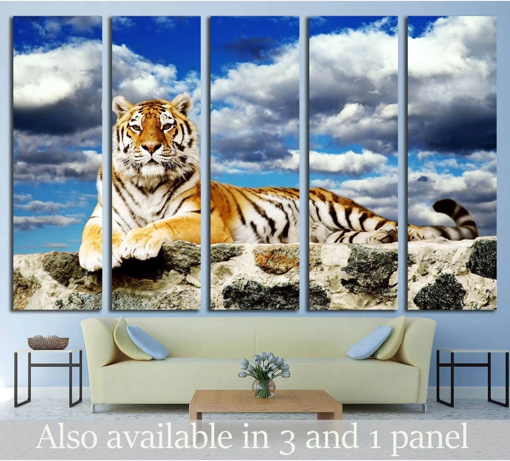 Tiger canvas print split across five panels above a sofa with storm clouds and blue sky
