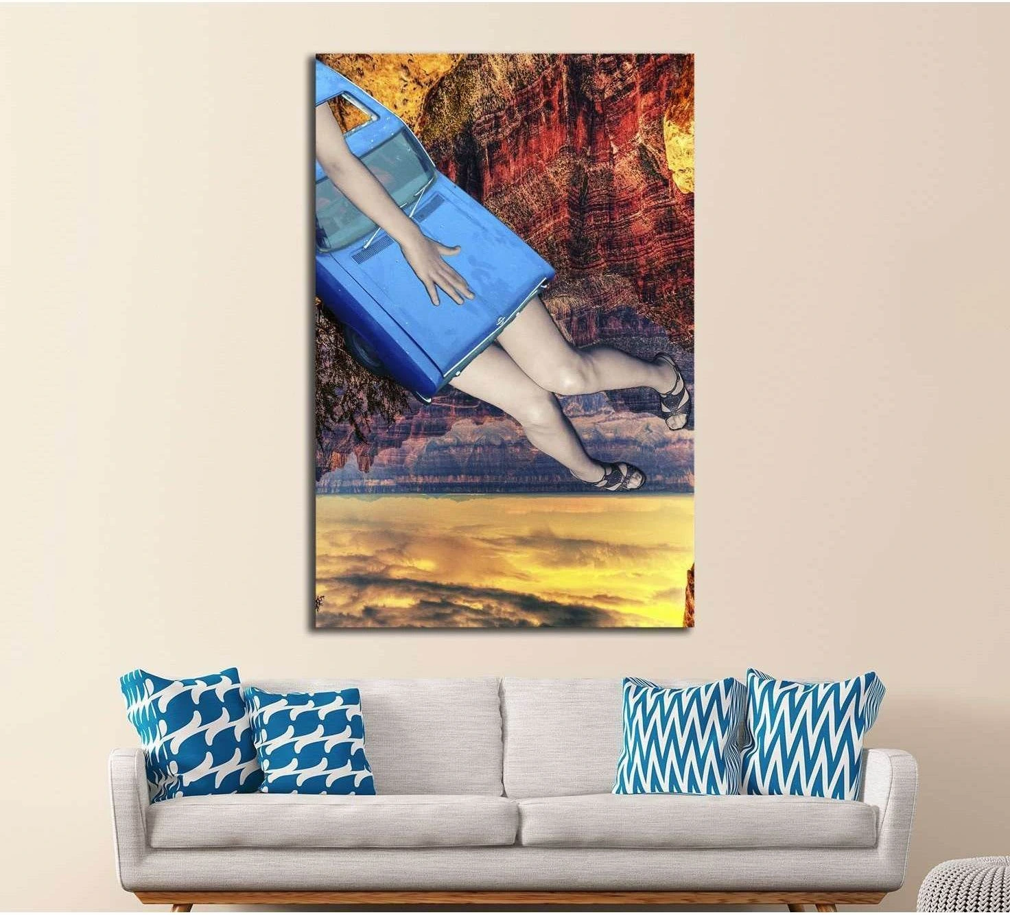 Surreal car collage canvas print with blue car body, women's legs, and canyon sunset above a sofa