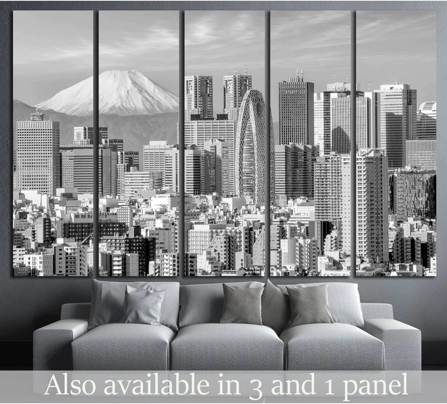 Black and white Tokyo skyline canvas print with Mount Fuji, shown as multi-panel wall art above a gray sofa