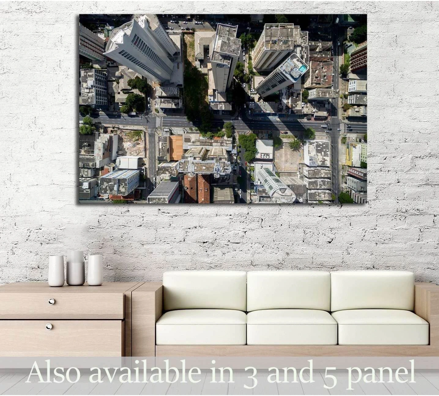 Aerial cityscape canvas print with top-down skyscrapers and streets hung above a sofa in a modern living room