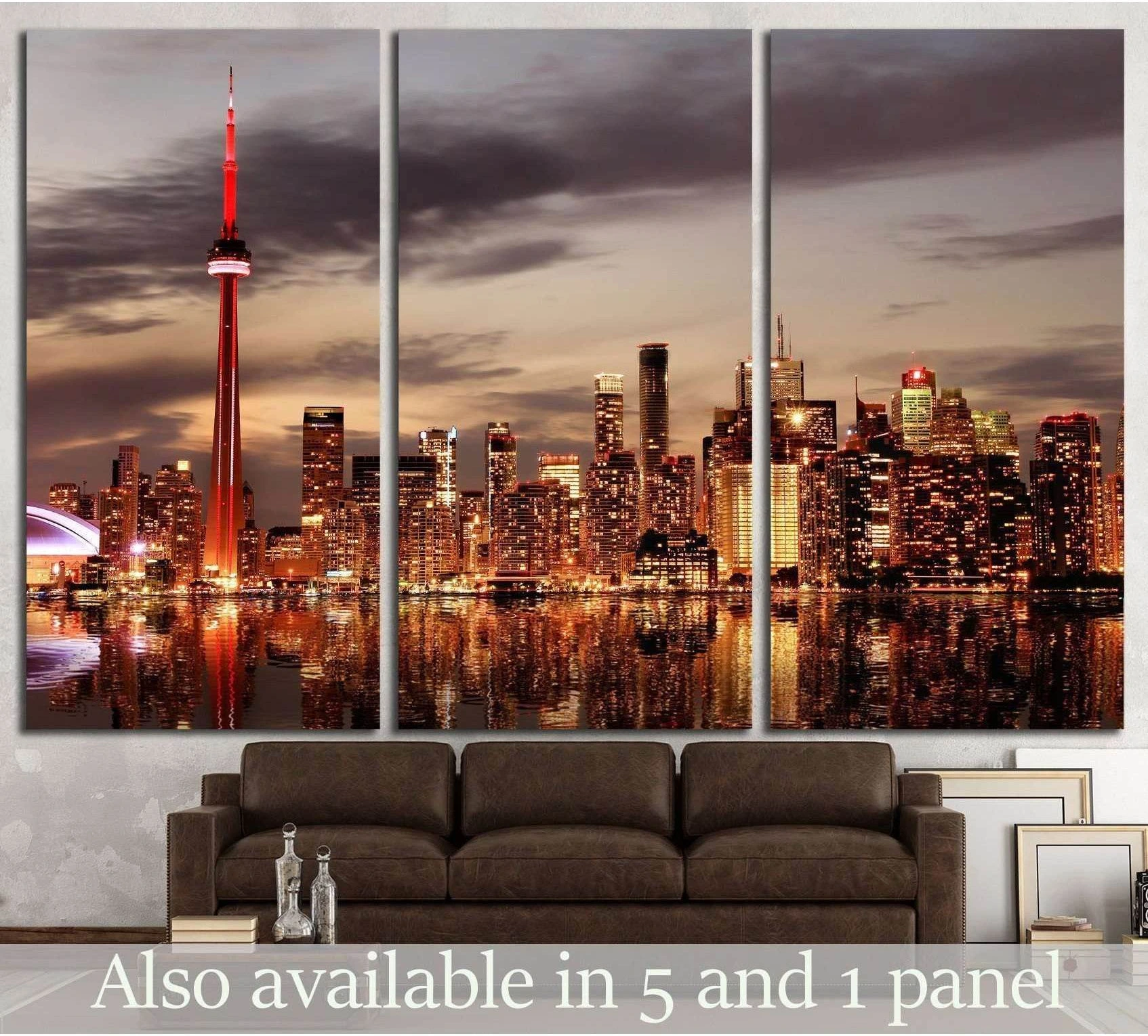 Toronto skyline triptych canvas print with CN Tower at sunset above a sofa in a modern living room