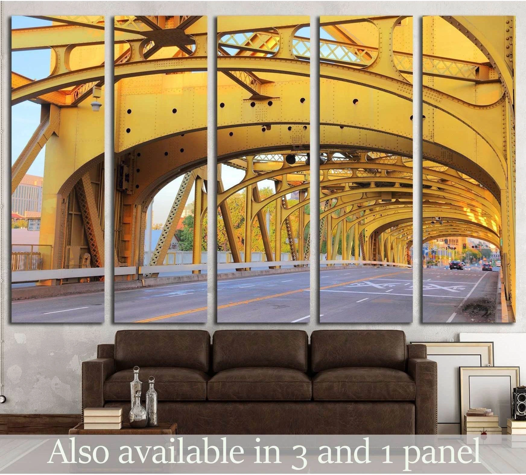 Yellow Sacramento Tower Bridge canvas print with repeating steel arches above a sofa in a modern living room