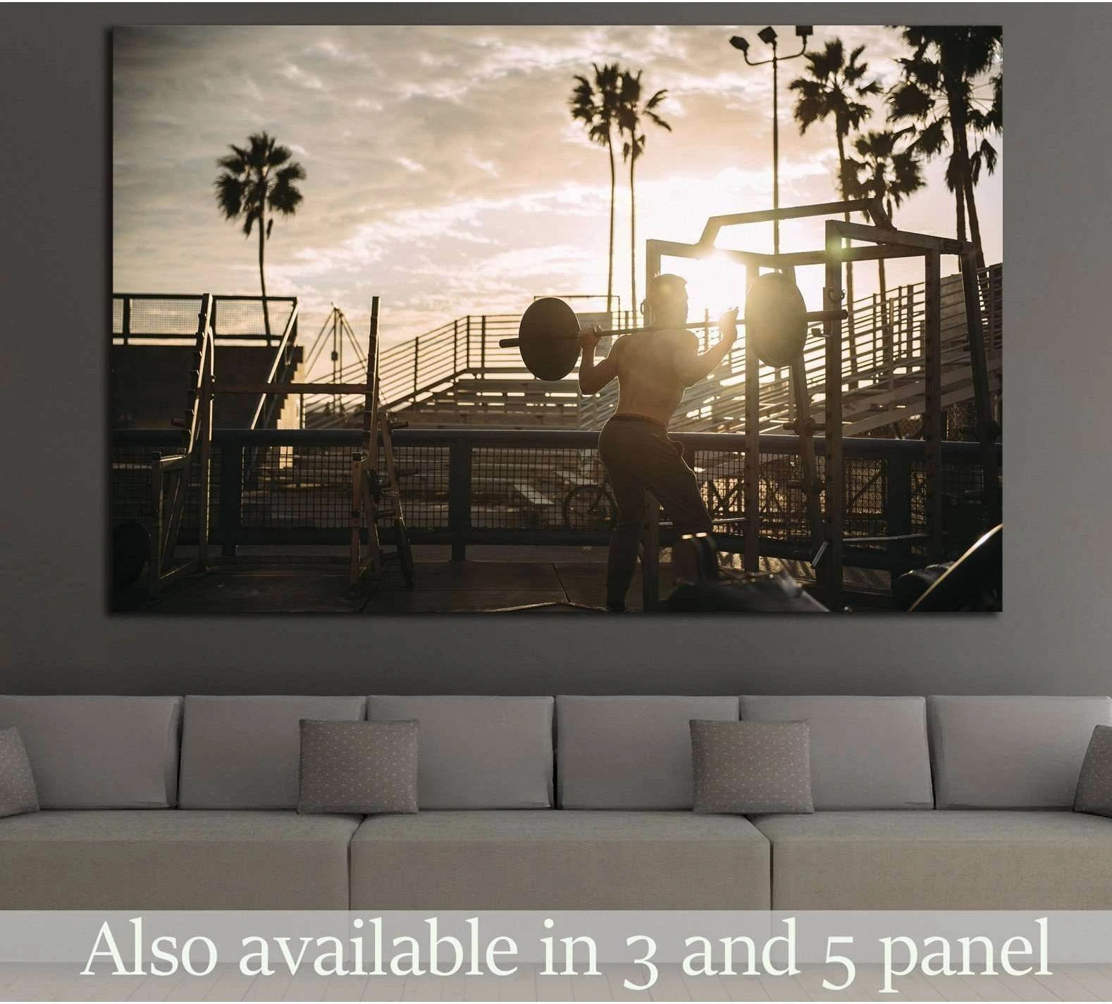 Beach gym barbell canvas print with silhouetted lifter at sunset above a sofa in a modern room