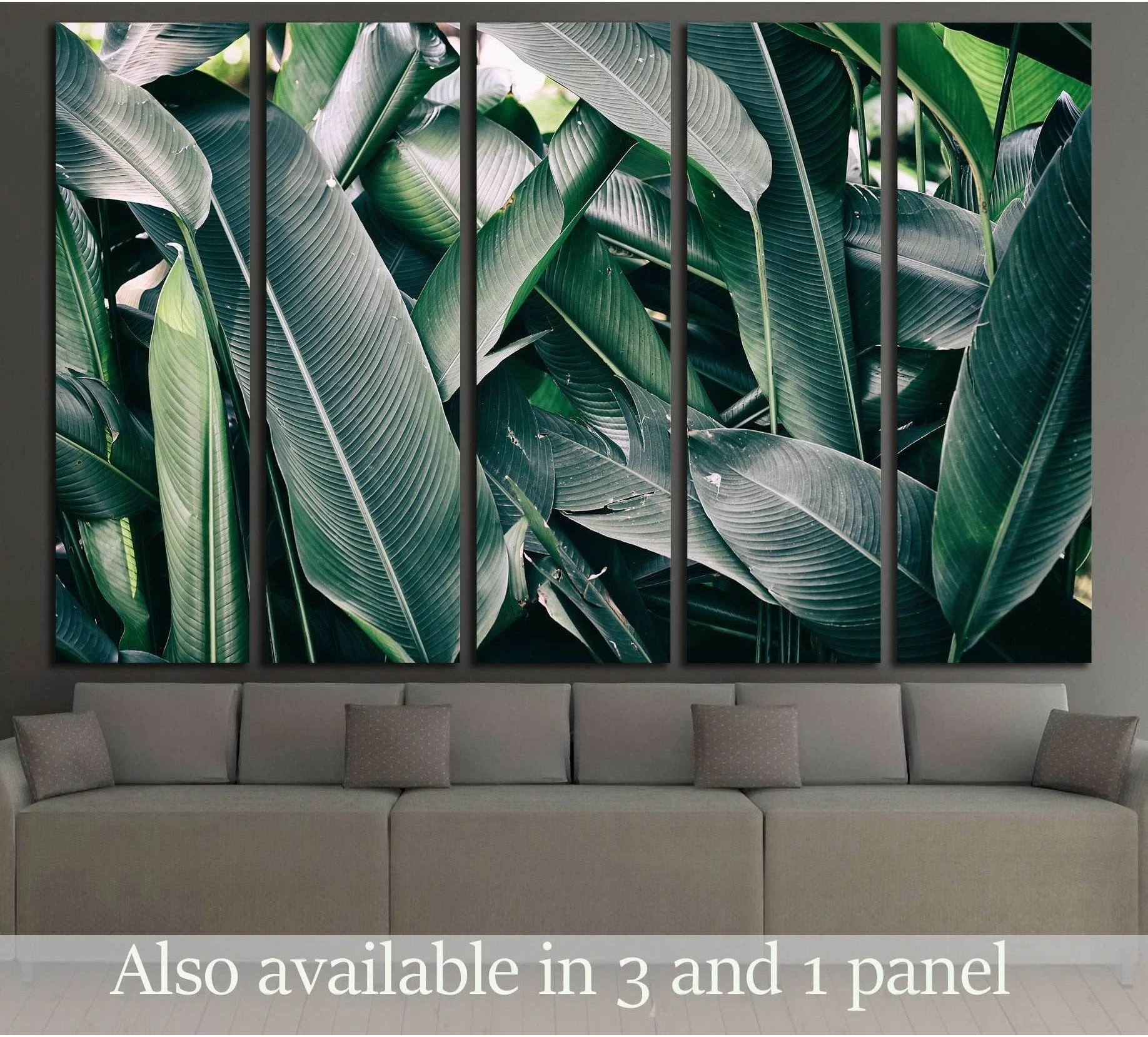Layered tropical banana leaves canvas print hung above a sofa in a modern living room