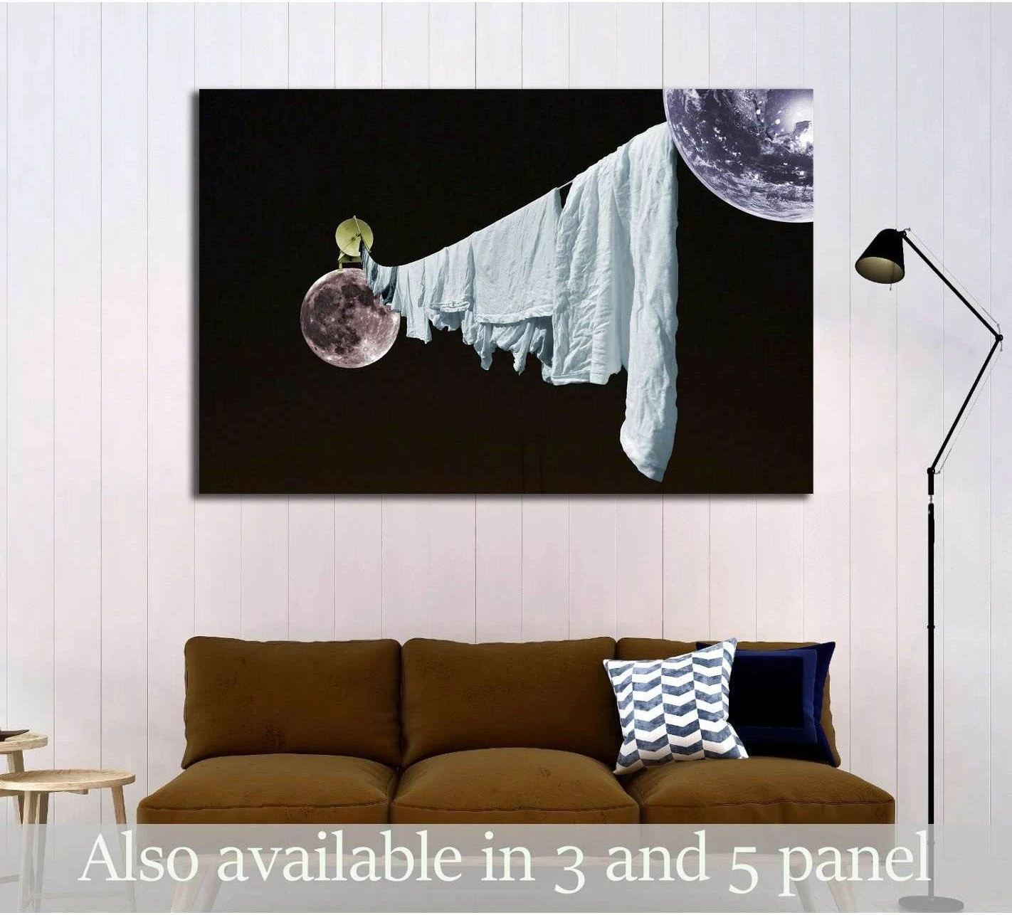 Surreal moon laundry canvas print with white sheets stretched between planets above a sofa