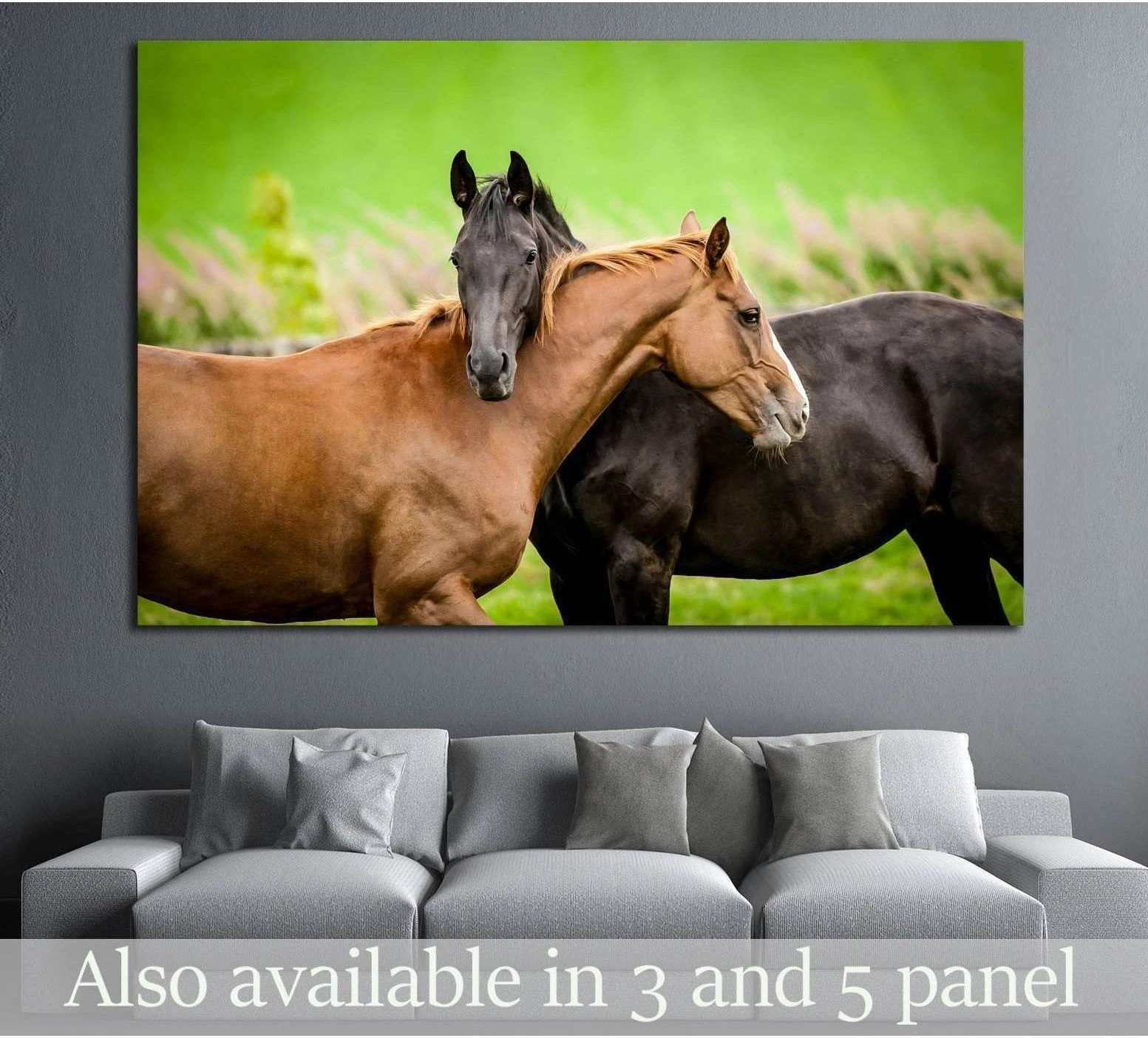 Two horses canvas print with a chestnut and black horse nuzzling in a green pasture above a gray sofa