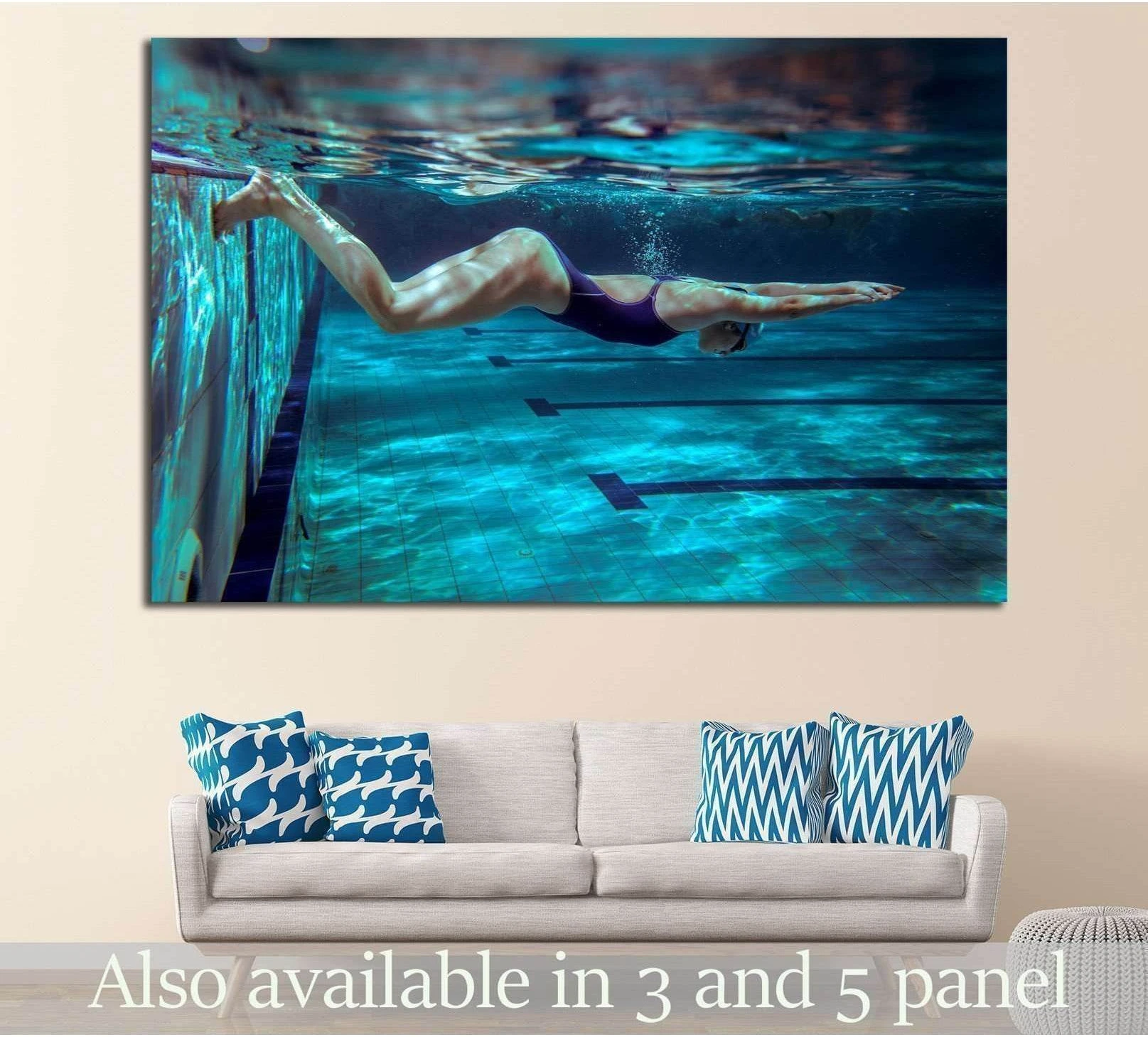 Female swimmer underwater in blue pool canvas print displayed above sofa in modern living room